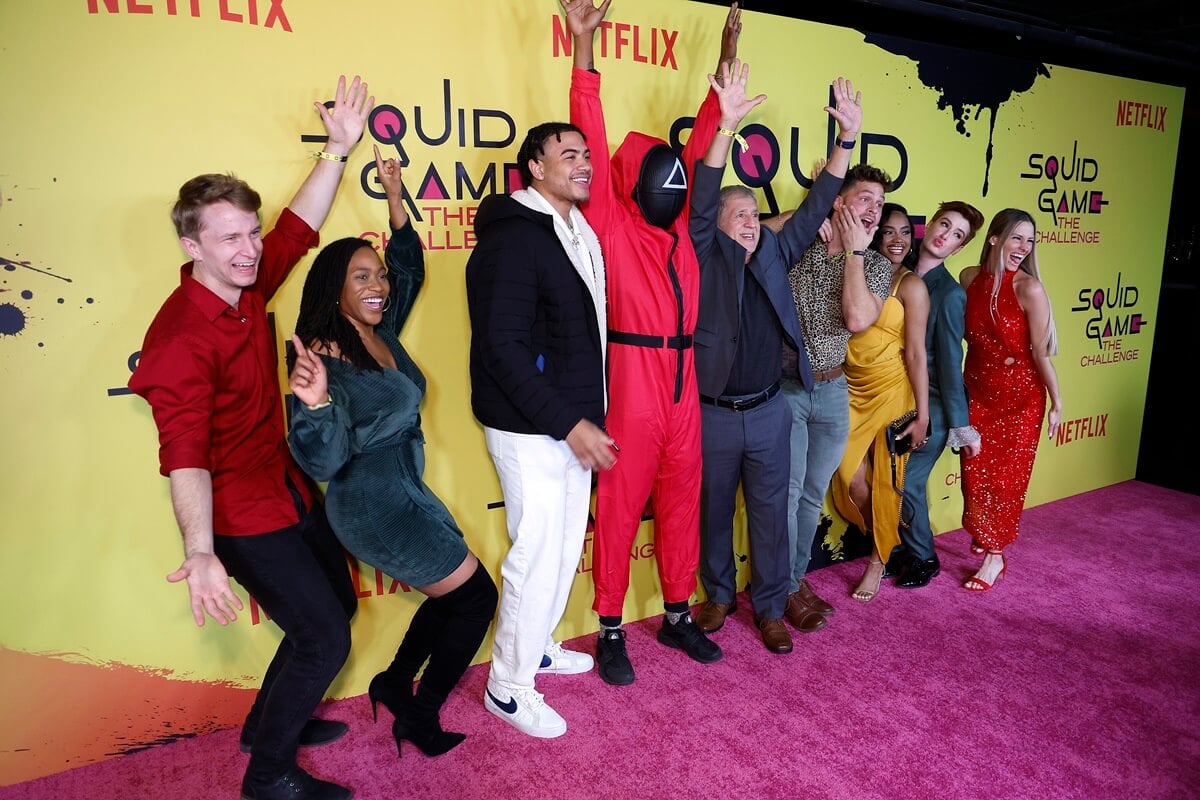 Contestants Spencer Hawkins, Ashley Tolbert, Bryton Constantin, Rick Mercurio, Stephen Lomas, Jada Fordyce, Dash Katz, and Jessica Figueroa cheer on the red carpet for Netflix's "Squid Game: The Challenge."