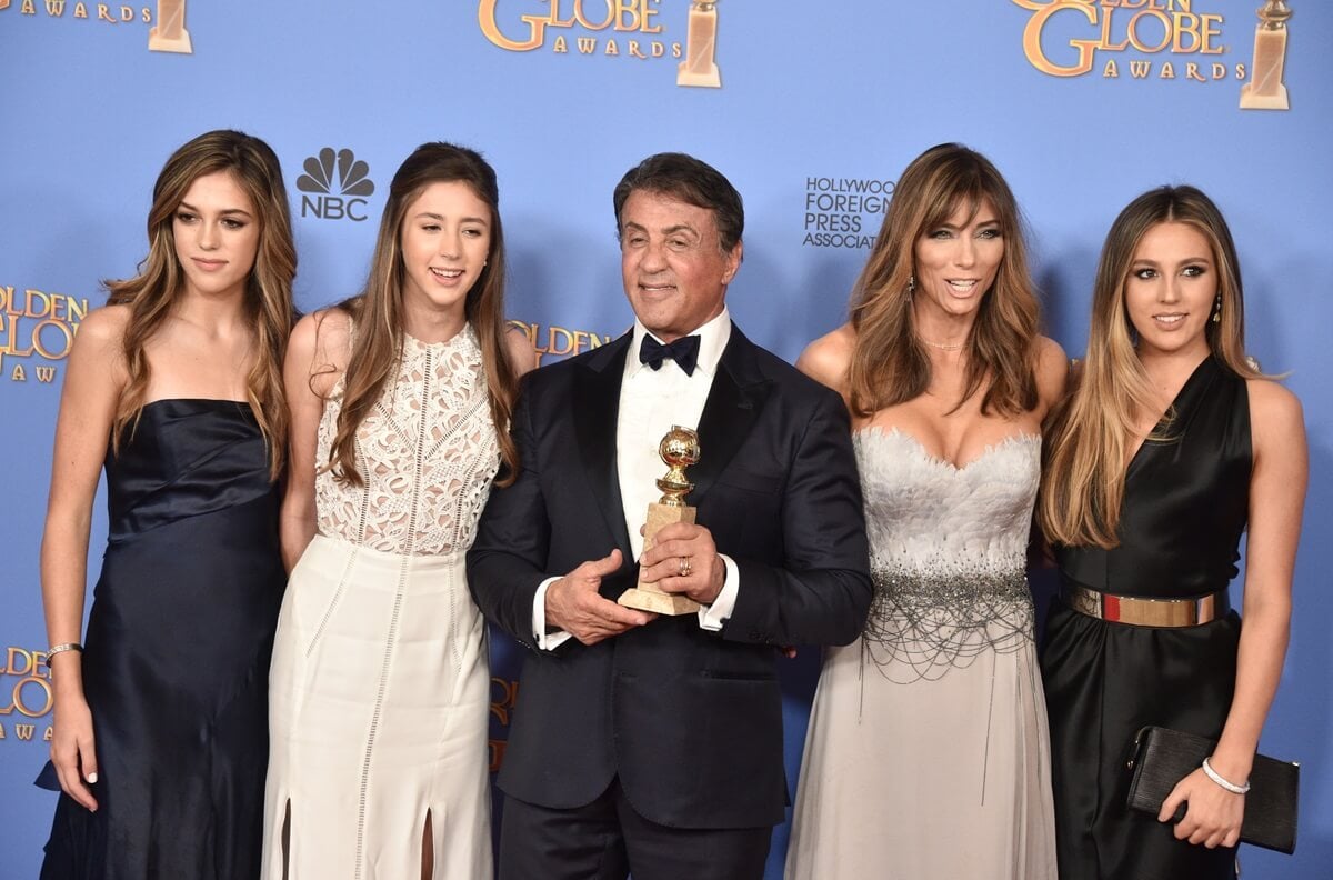 Sylvester Stallone posing at the Golden Globes with daughters Sophia, Sistine, and Scarlet Stone and his wife Jennifer Flavin.
