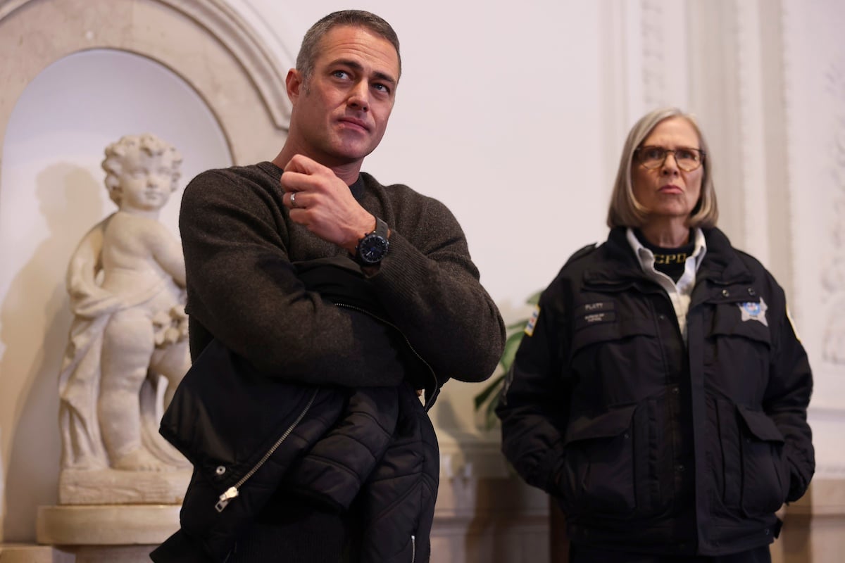 Taylor Kinney standing next to Trudy in an episode of 'Chicago Fire'