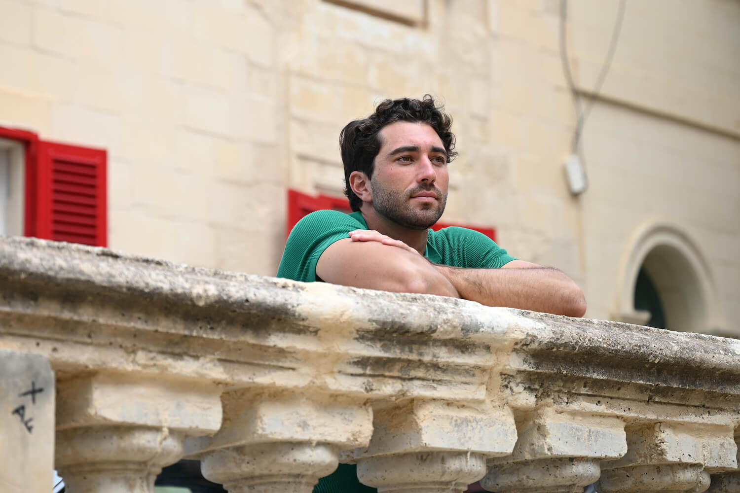 'The Bachelor' Season 28 star Joey Graziadei resting his arms on a stone banister in episode 4