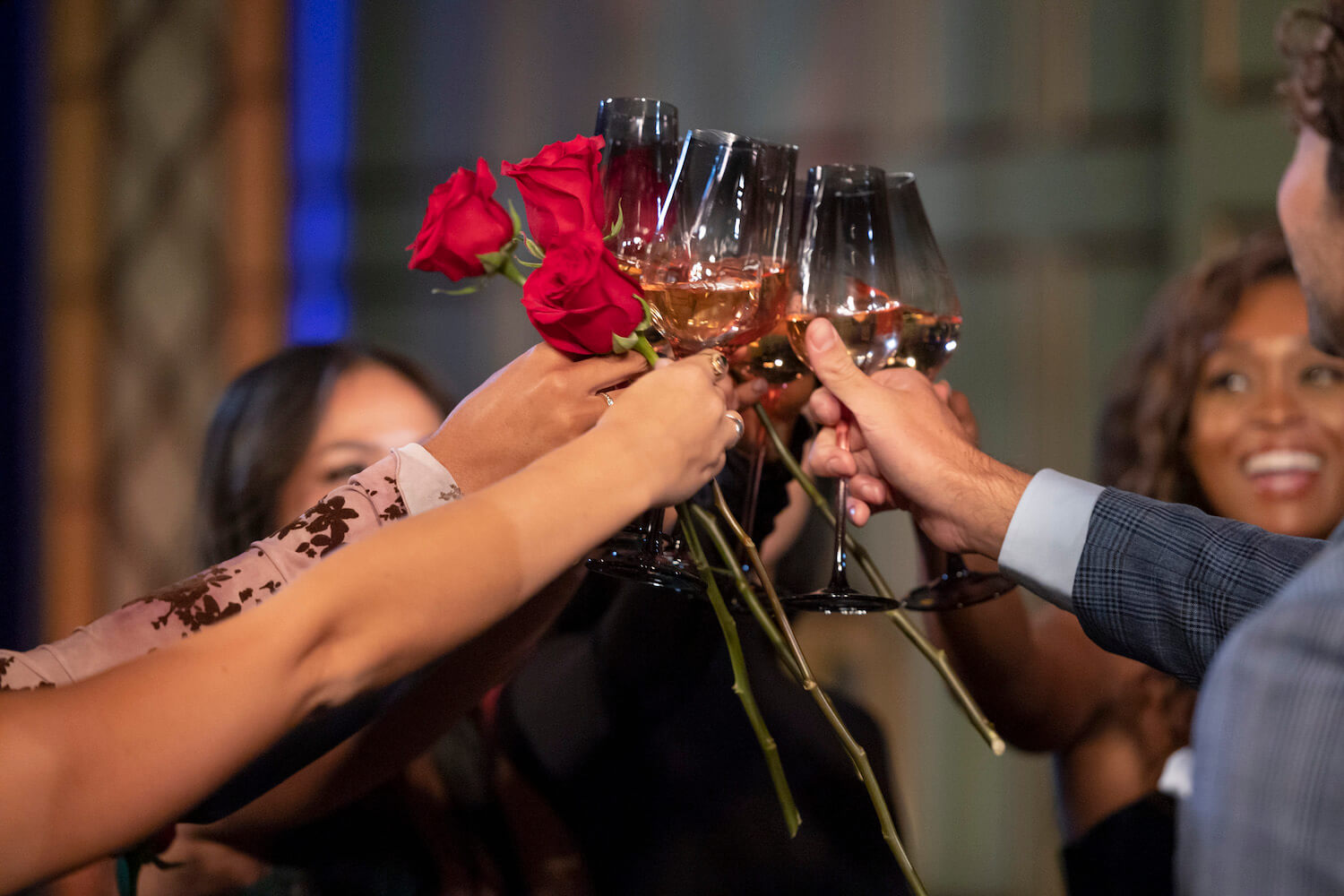 Joey Graziadei and his final cast members toasting with wine glasses and roses in 'The Bachelor' Season 28