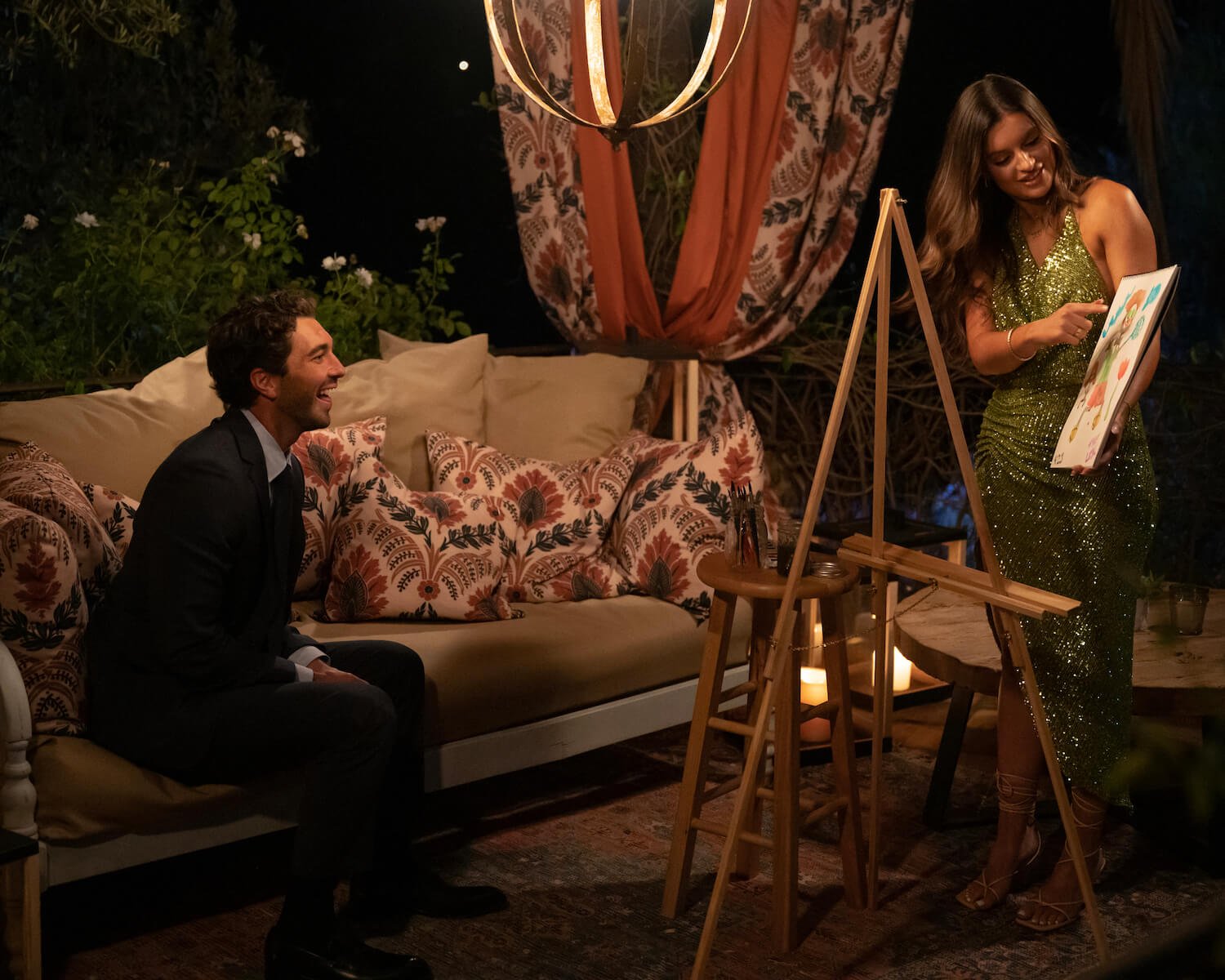 'The Bachelor' Season 28 star Joey Graziadei sitting and watching Lexi Young paint for him