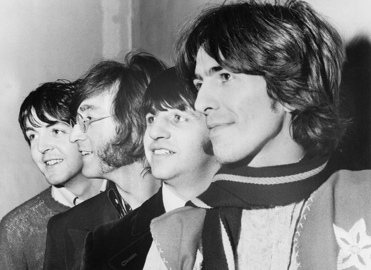 A black and white picture of Paul McCartney, John Lennon, Ringo Starr, and George Harrison standing in a line.