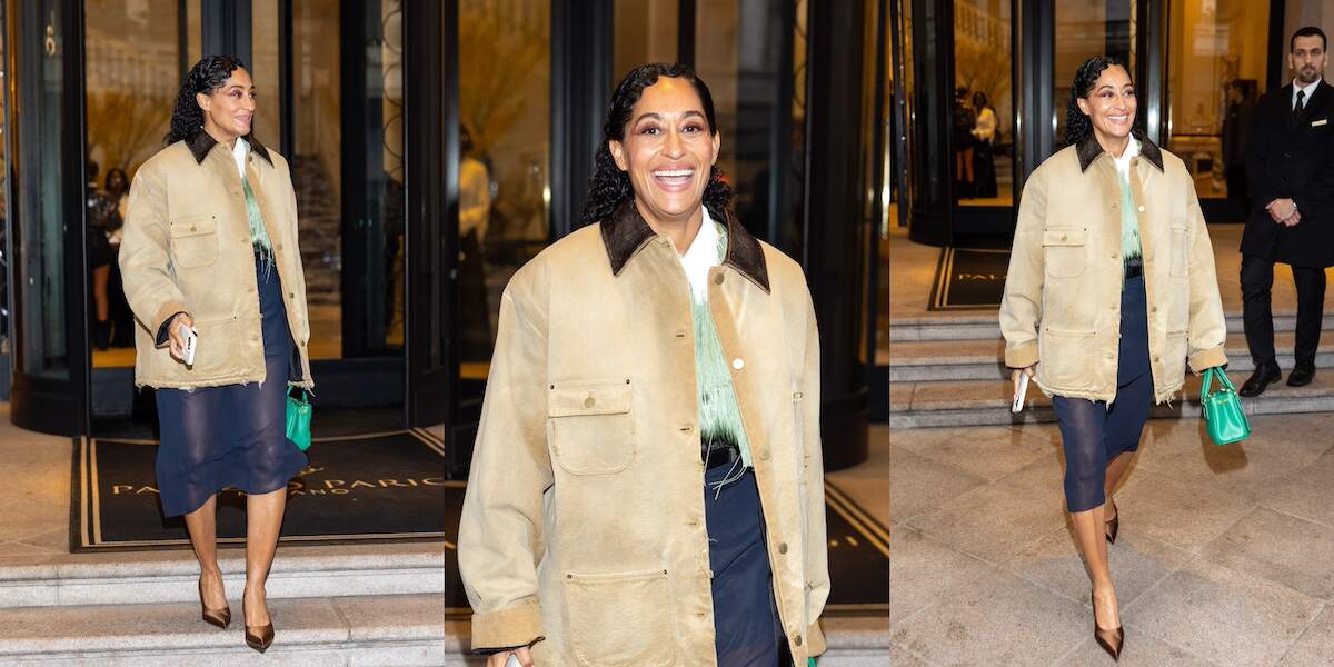 Actor Tracee Ellis Ross walks down the steps of her hotel wearing a workwear-inspired tan jacket and navy skirt