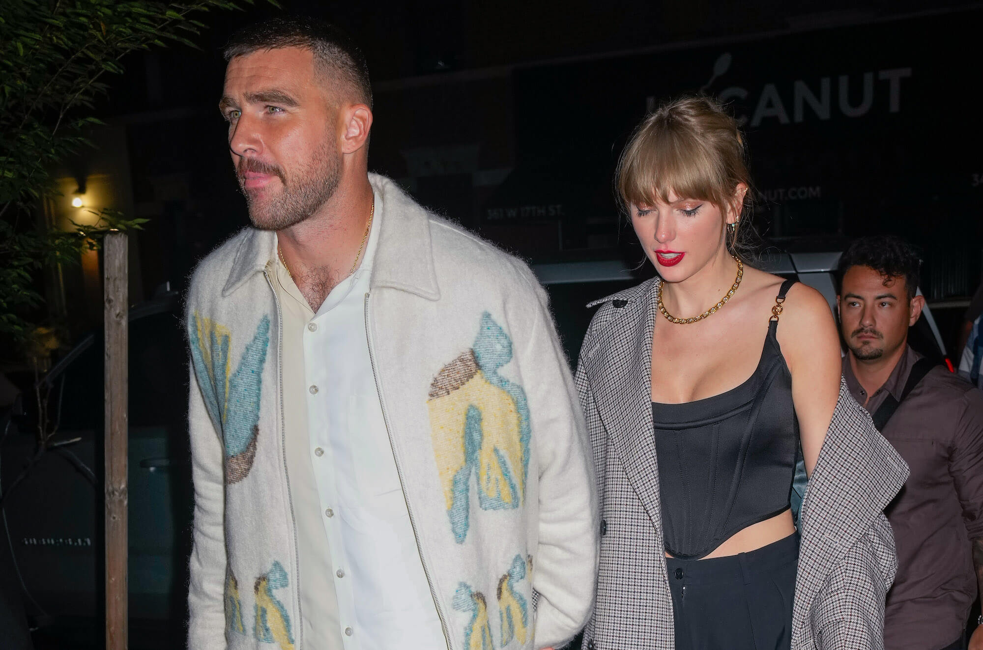 Travis Kelce walking in front of Taylor Swift after an 'SNL' after party