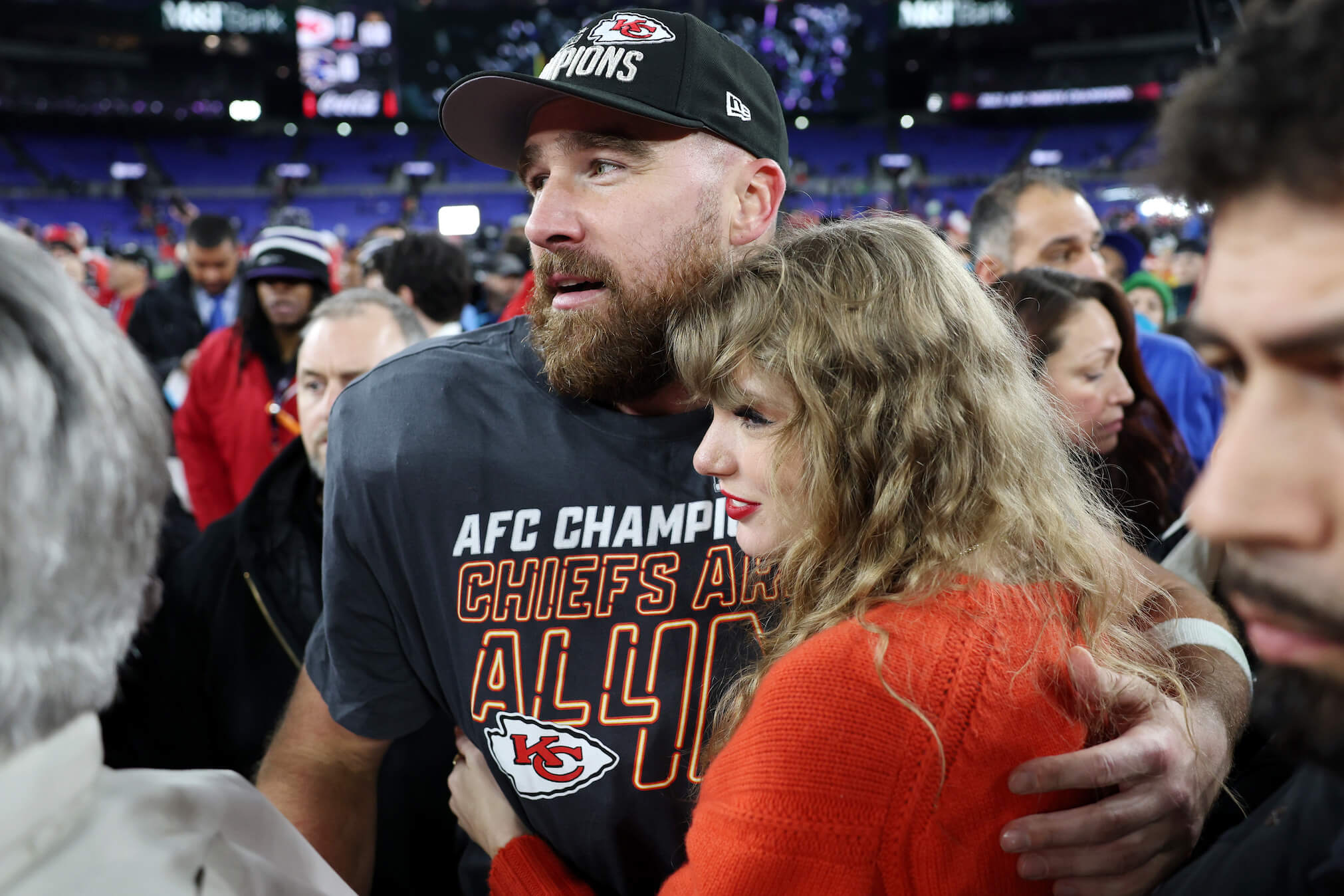Travis Kelce with his arm around Taylor Swift after a Kansas City Chiefs game