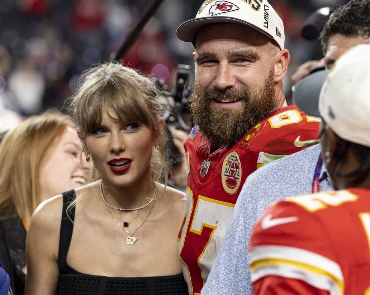 Travis Kelce and Taylor Swift on the field together following the Kansas City Chiefs Super Bowl win