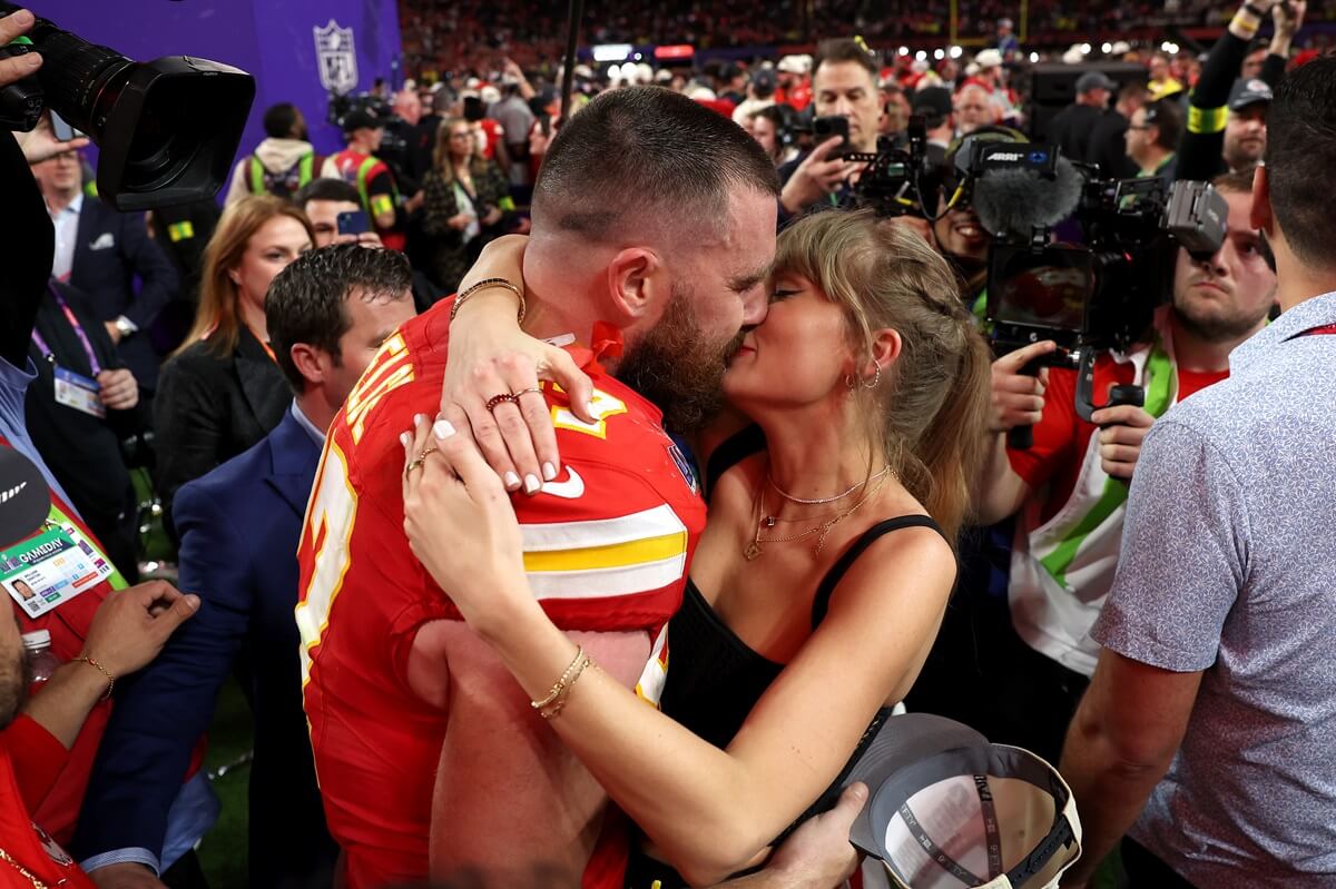 Travis Kelce and and Taylor Swift kiss after the Kansas City Chiefs defeat the San Francisco 49ers in overtime during Super Bowl LVIII