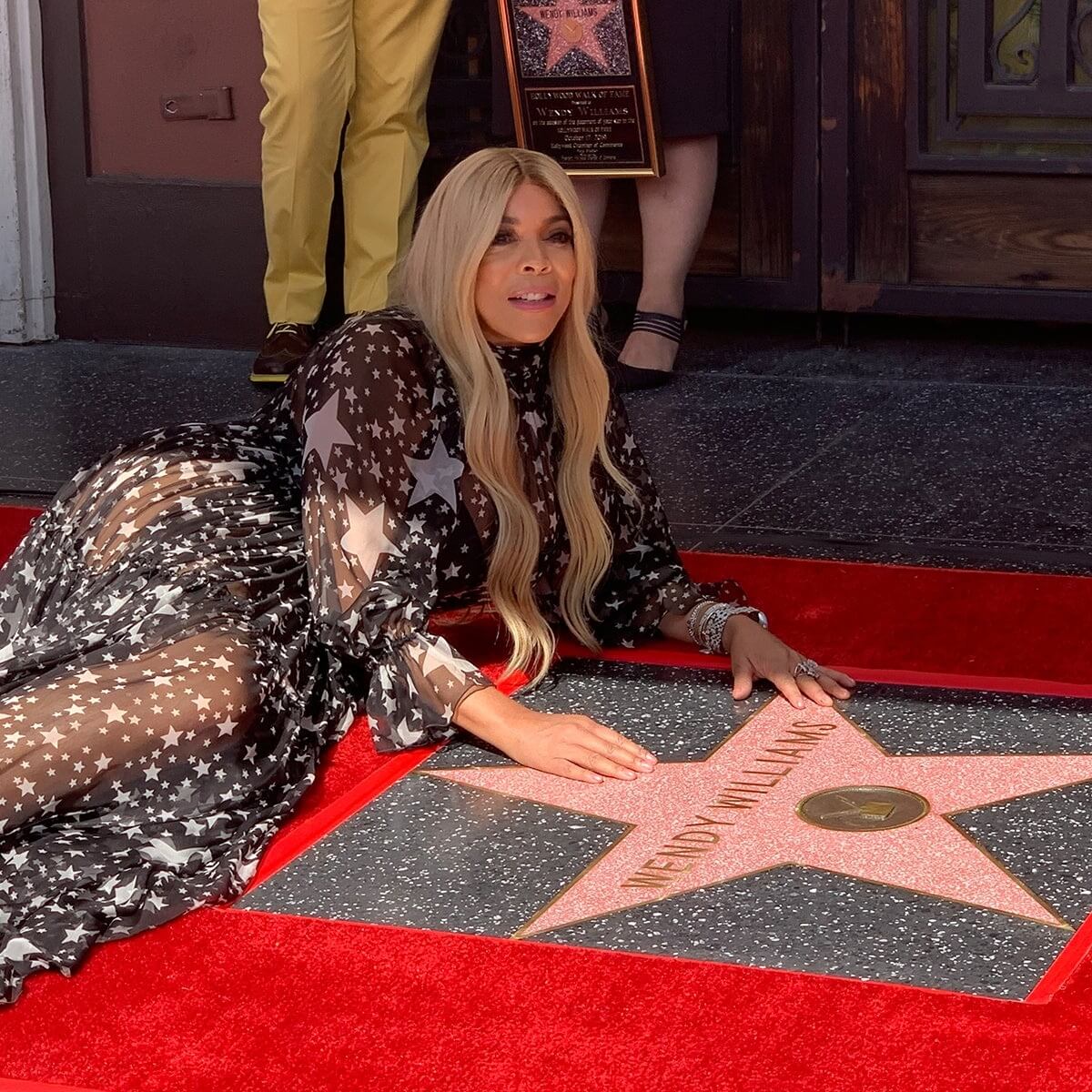 Wendy Williams lies on the ground next to her star on the Walk of Fame
