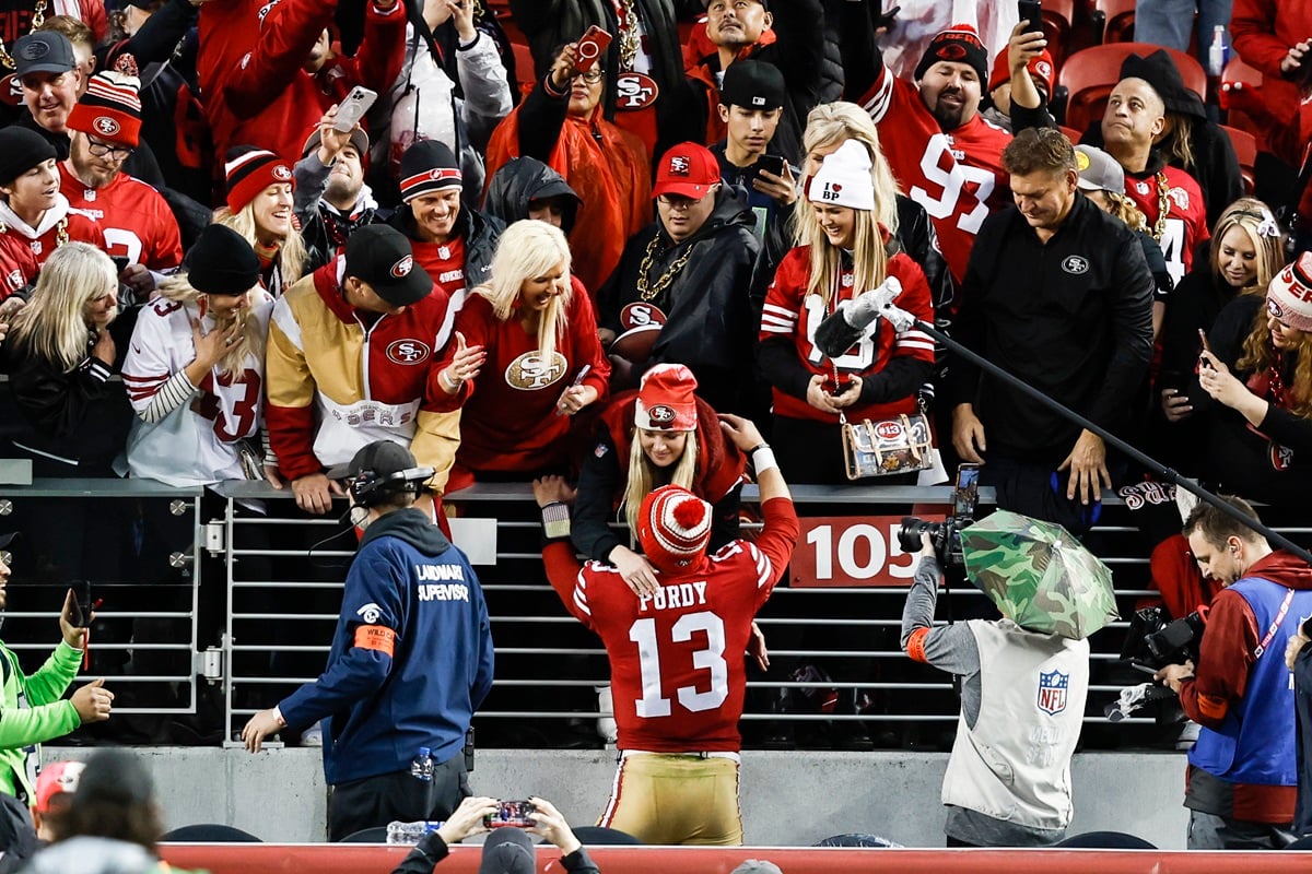 Brock Purdy #13 of the San Francisco 49ers hugs his fiancee, Jenna Brandt, following an NFL football game between the San Francisco 49ers and the Seattle Seahawks at Levi's Stadium on January 14, 2023