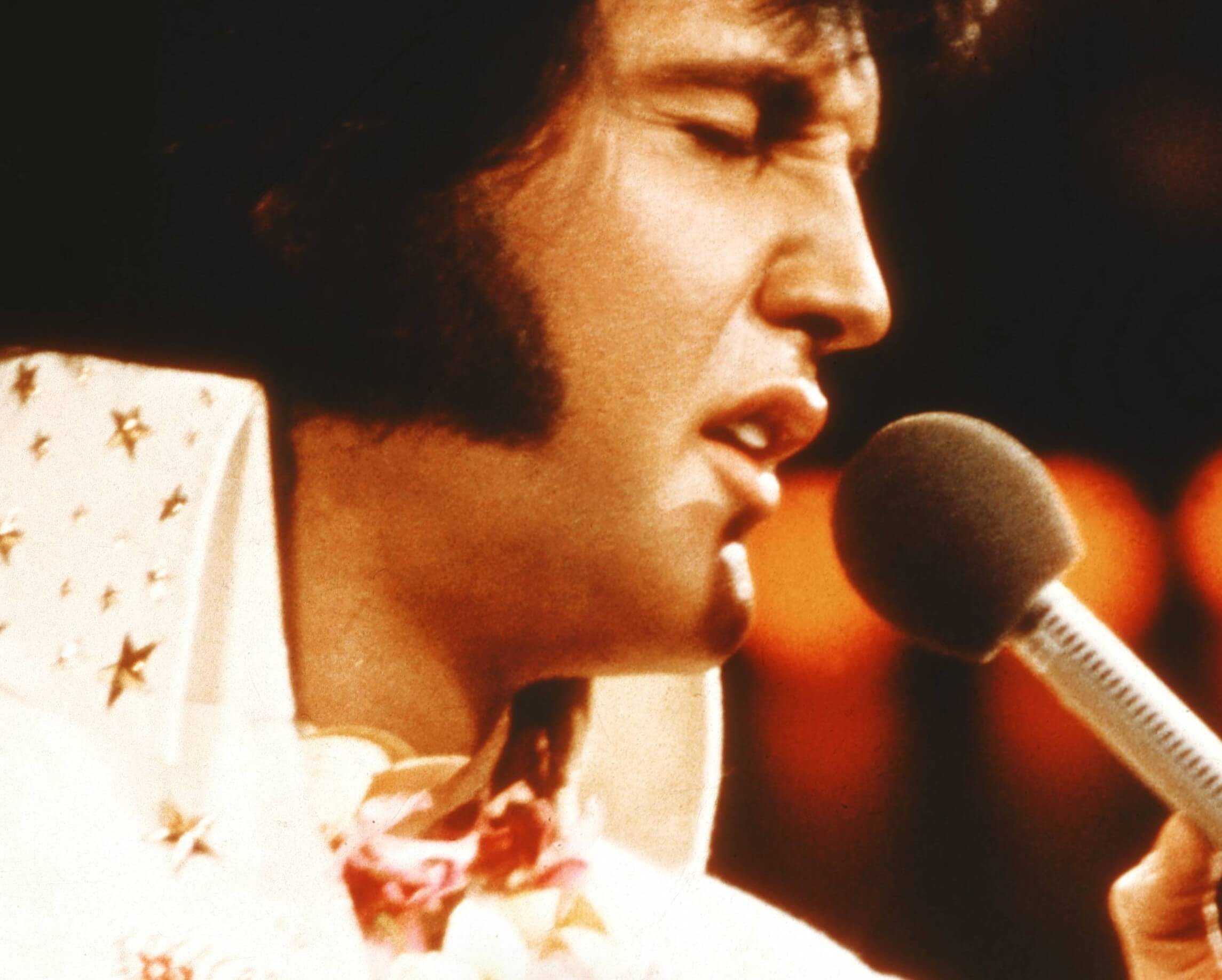 "Burning Love" singer Elvis Presley with a microphone
