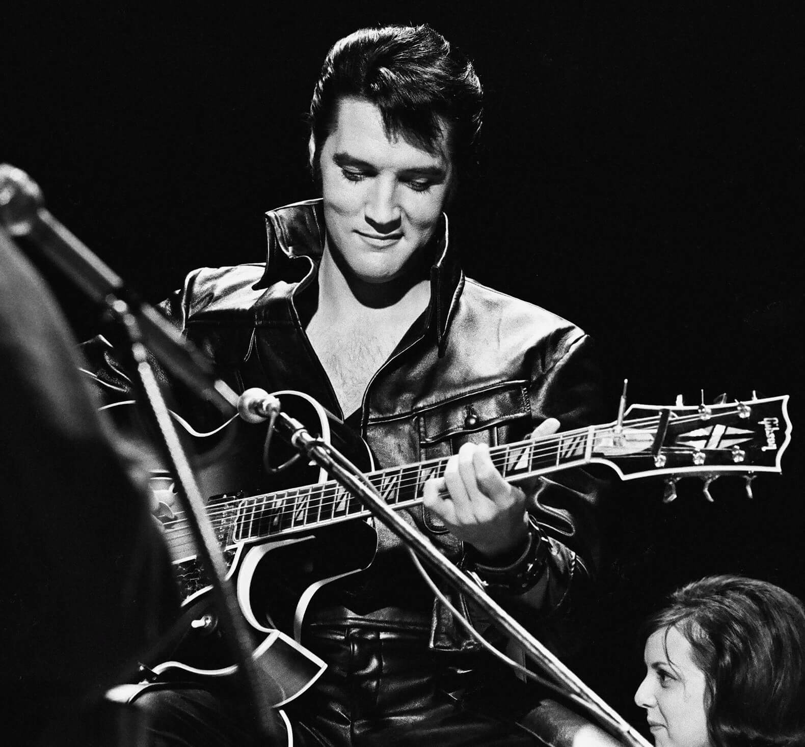 "Trouble" singer Elvis Presley with a guitar