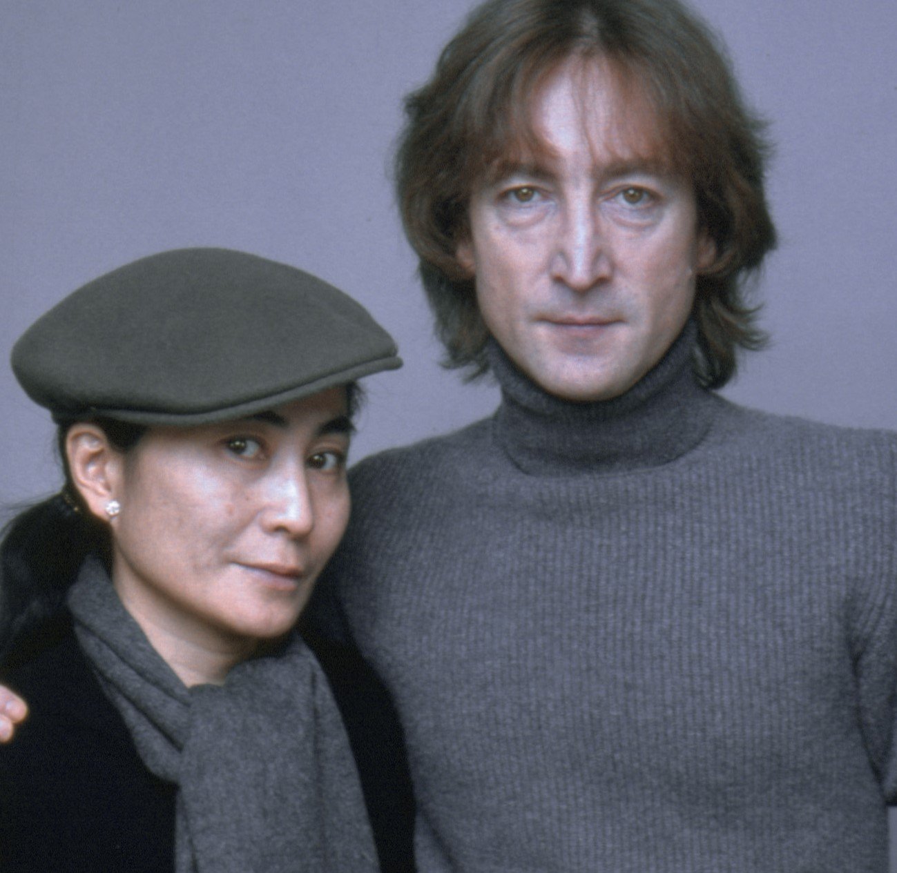 Yoko Ono and John Lennon wearing gray