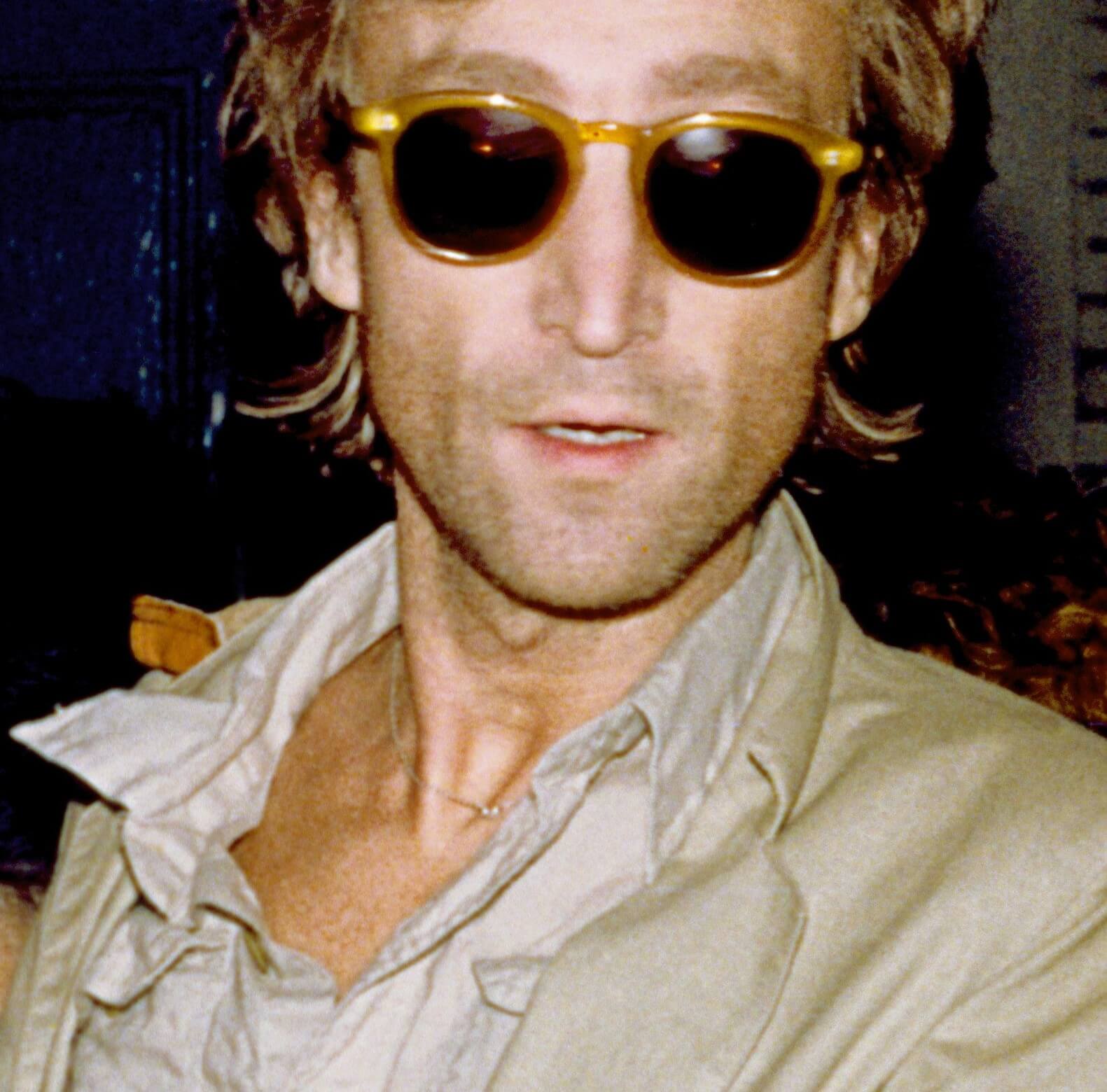 John Lennon wearing dark glasses