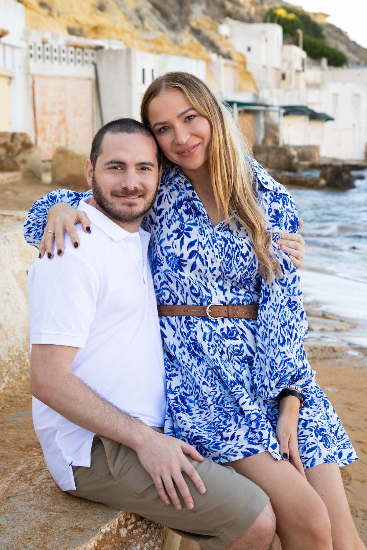 Kyle and Anika pose for a photo on a beach in Malta