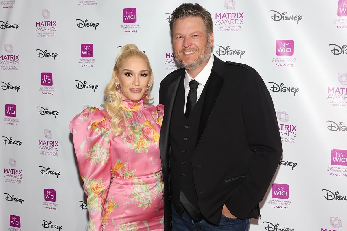 Blake Shelton and Gwen Stefani posing next to each other at The Matrix Awards.