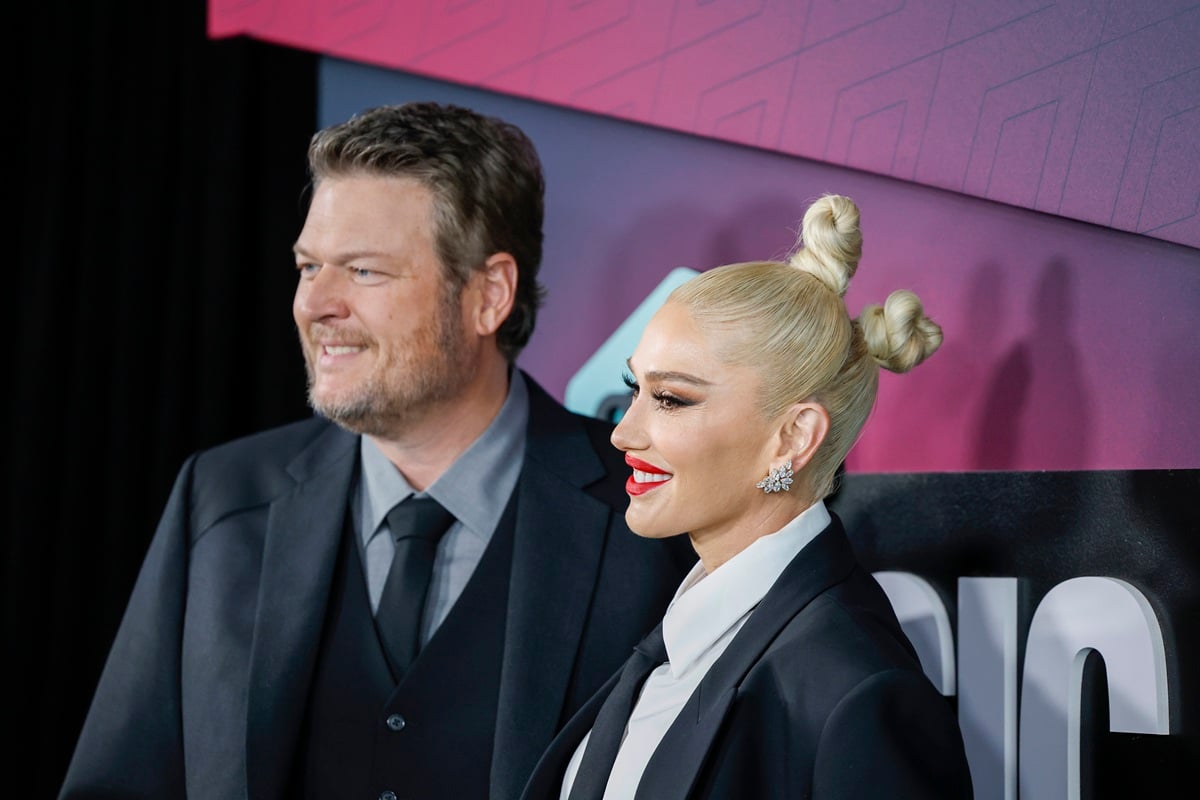 Blake Shelton and Gwen Stefani posing in suits at the 2023 CMT Music Awards at Moody Center.