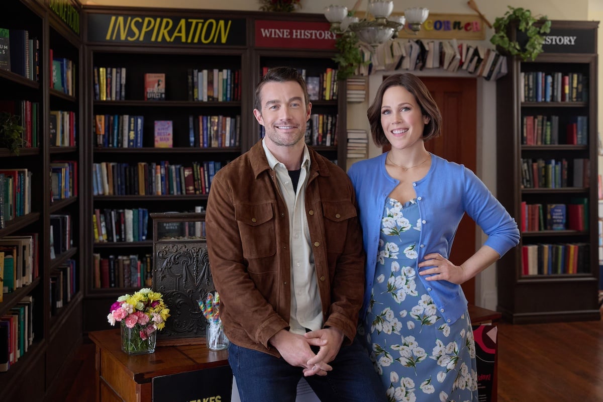Robert Buckley and Erin Krakow standing in a bookstore in Hallmark movie 'Blind Date Book Club'