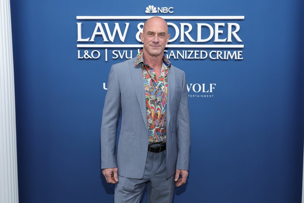 Chris Meloni posing in a blue suit at the Law & Order Press Day Red Carpet.