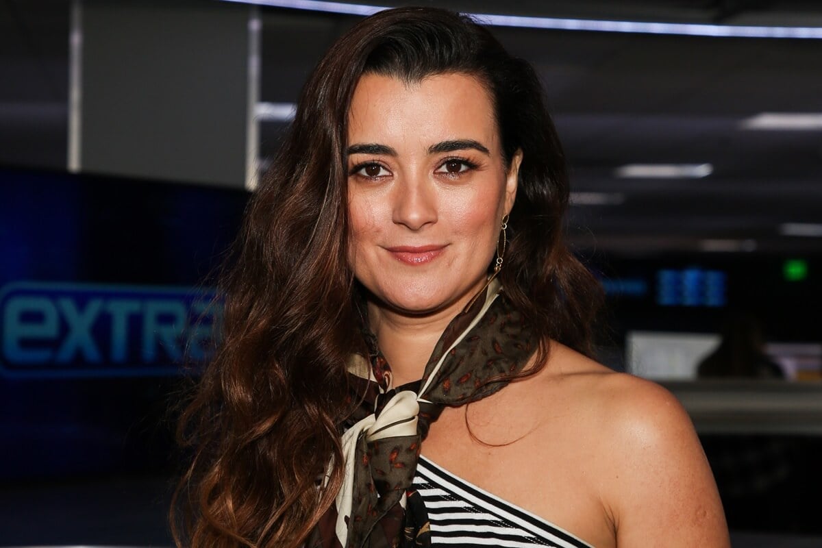 Cote De Pablo posing in a dress while visiting "Extra" at Burbank Studios.
