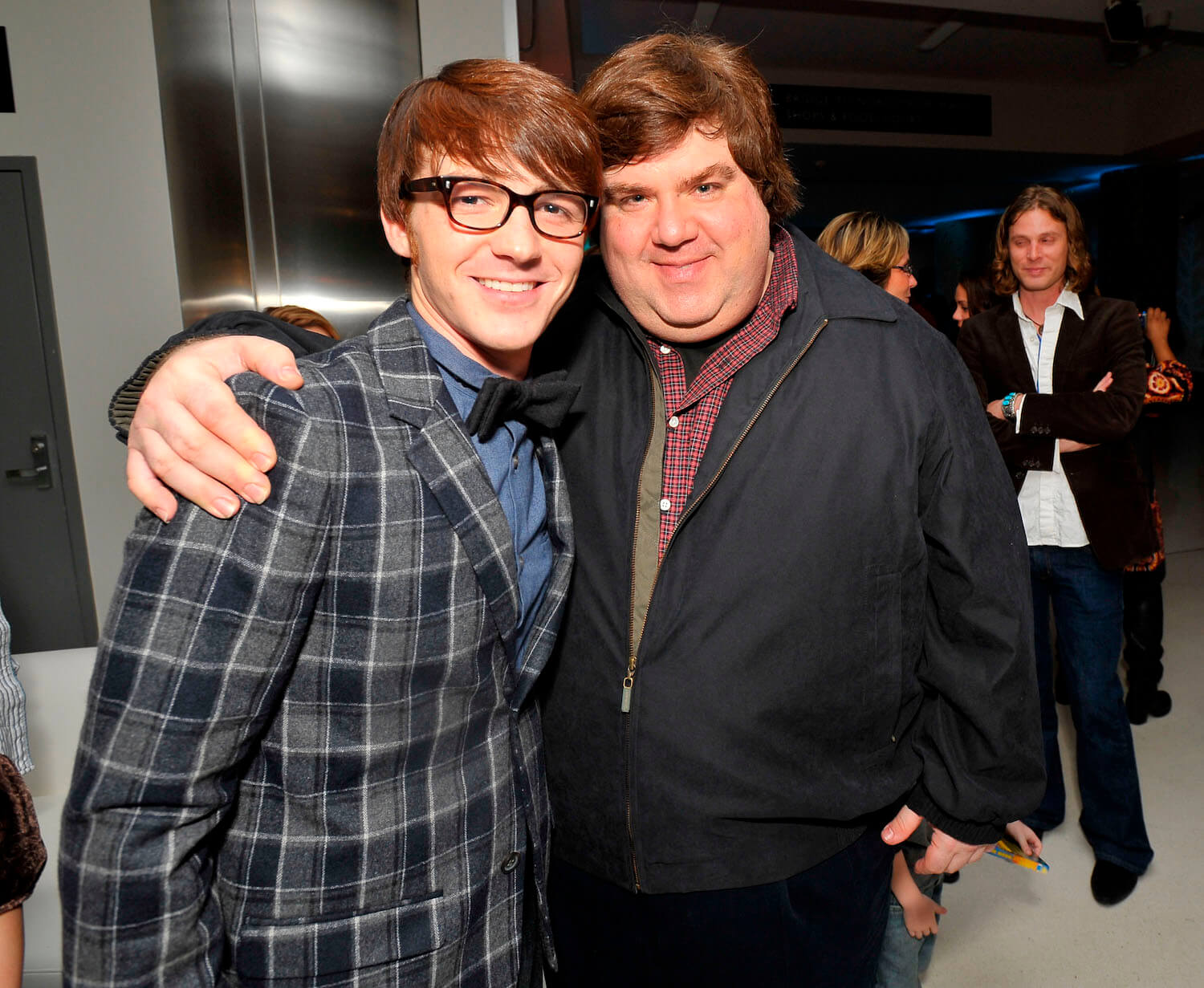 Nickelodeon star Drake Bell and Dan Schneider hugging and smiling