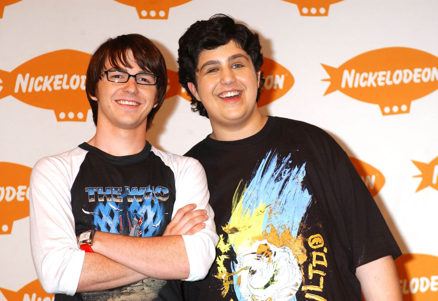 Drake Bell and Josh Peck from Nickelodeon's 'Drake & Josh' smiling at a network event