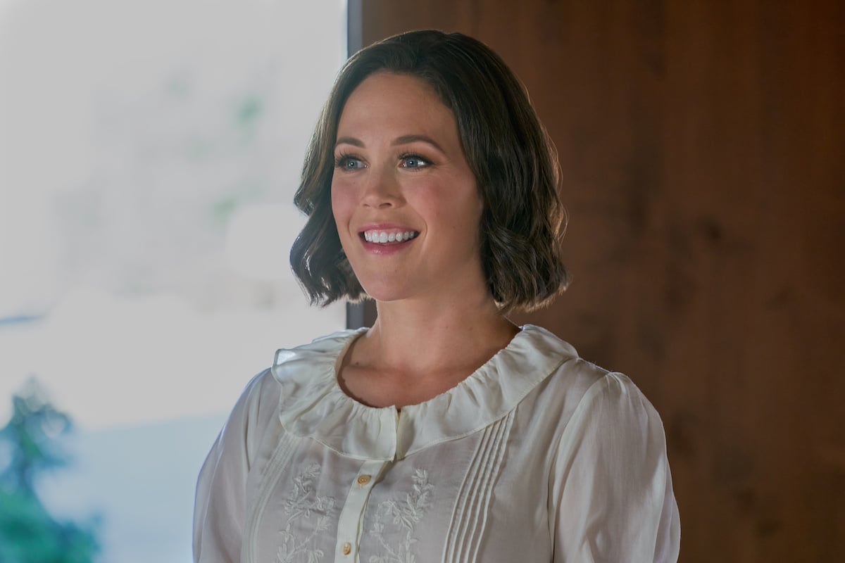 Smiling Erin Krakow in a white blouse in 'When Calls the Heart' Season 11