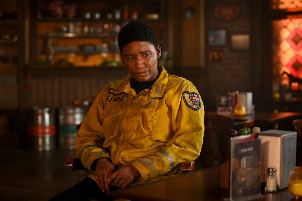 Jules Latimer with a dirty face and wearing firefighting gear in 'Fire Country'
