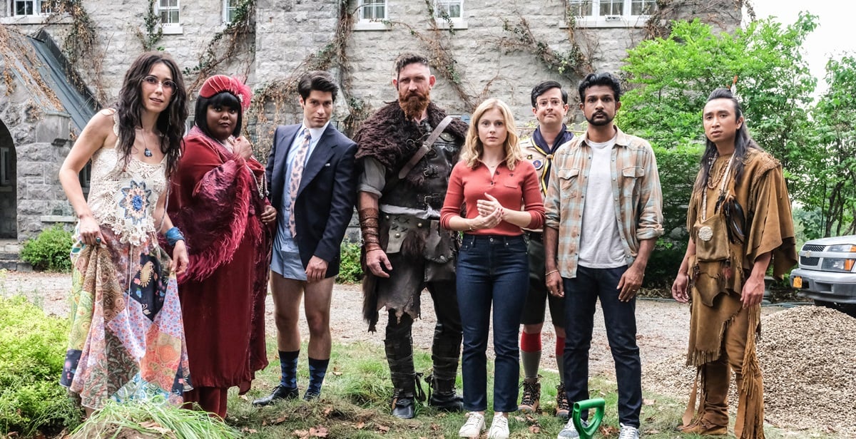 The cast of 'Ghosts' stands outside of 'Woodstone Mansion' in season 1