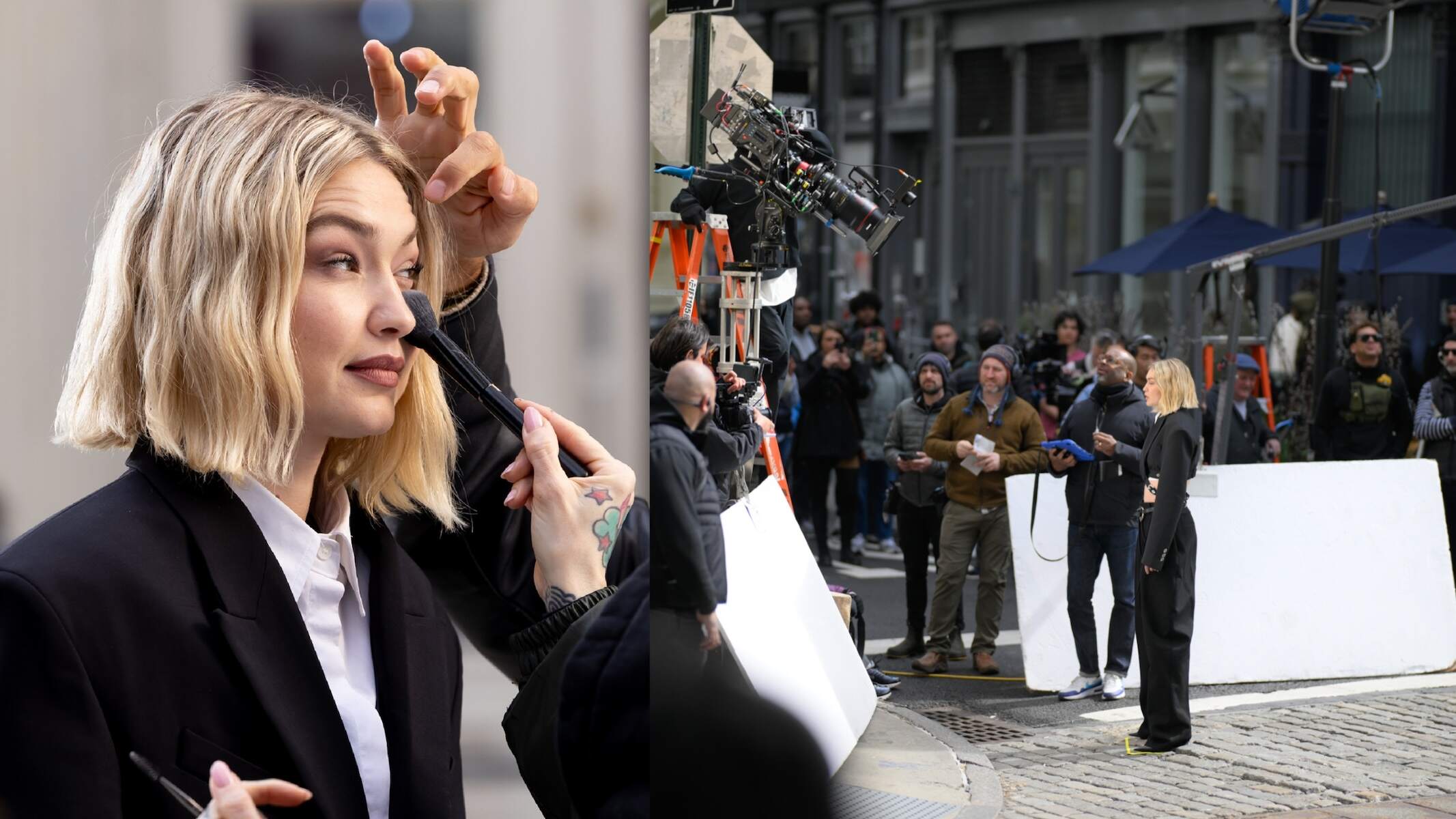 Model Gigi Hadid wears a black jacket and pants while filming a video for Maybelline on a NYC street