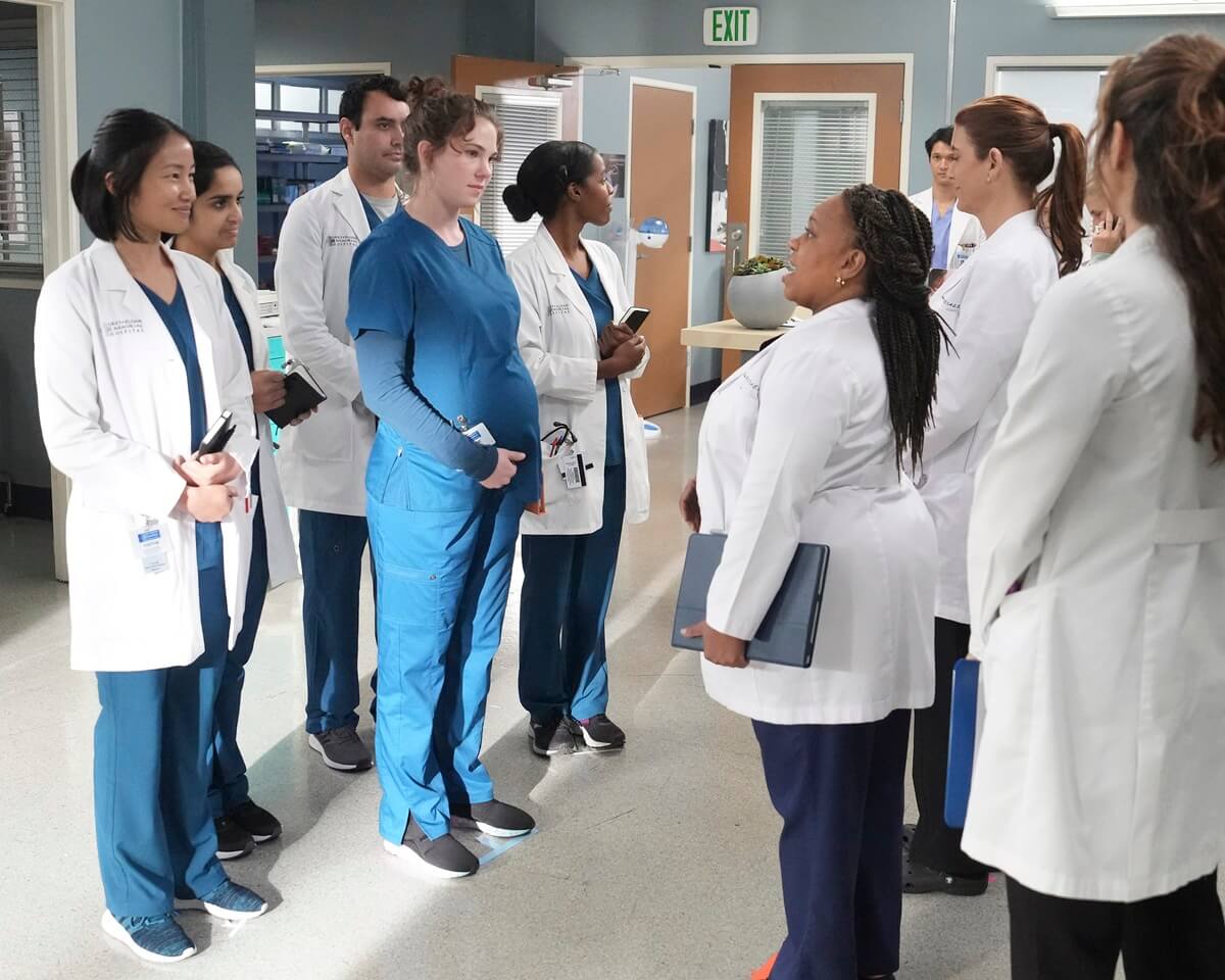 The cast of Grey's Anatomy all looking at each other.