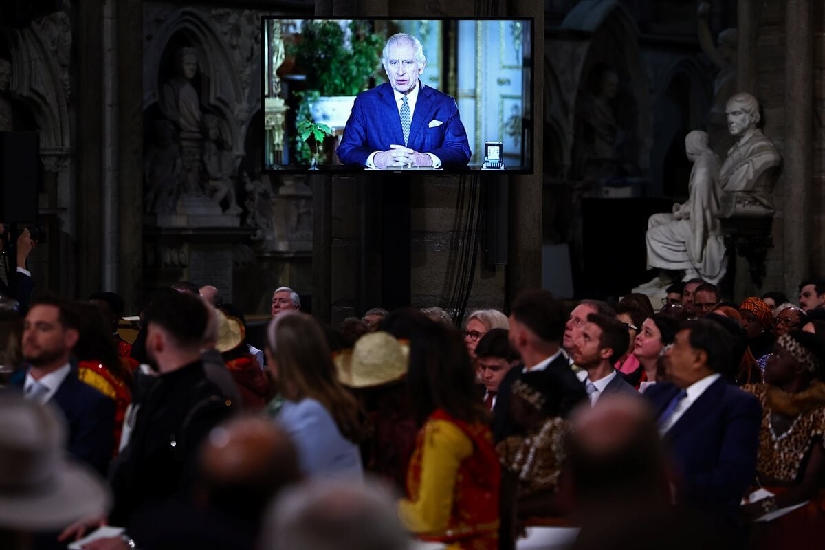 Guests watch a video of King Charles III delivering a message during the 2024 Commonwealth Day Service at Westminster Abbey