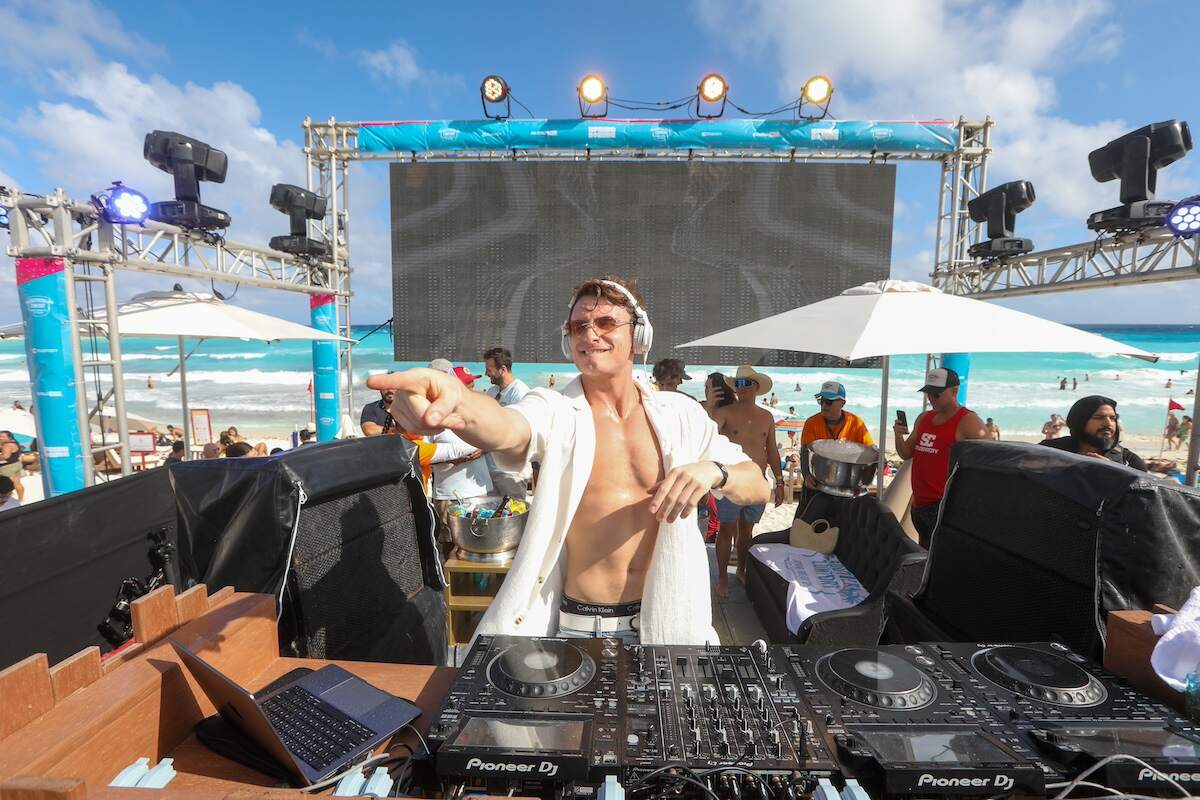 Vanderpump Rules star James Kennedy djs in Cancun to an excited crowd while wearing a white unbuttoned shirt