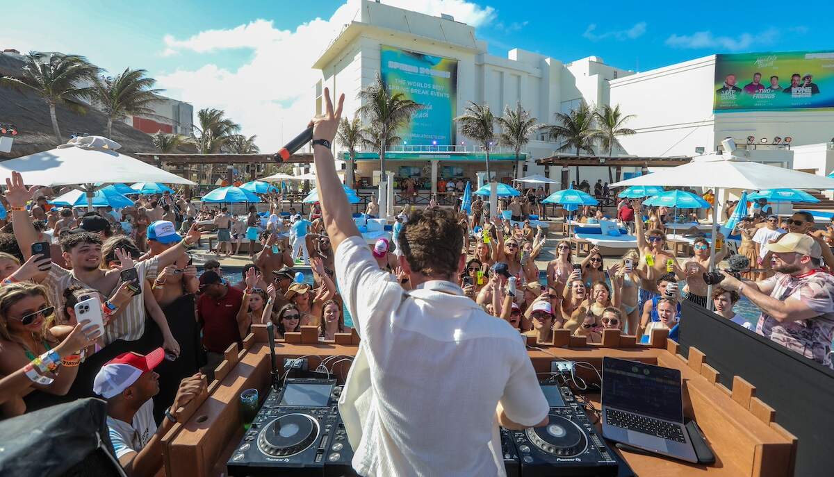 Vanderpump Rules star James Kennedy djs in Cancun to an excited crowd while wearing a white unbuttoned shirt