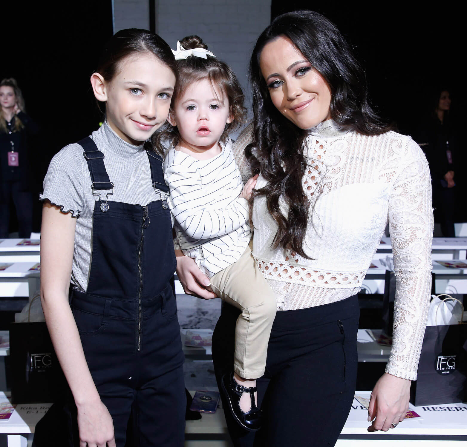 Jace Vahn Evans, Ensley Jolie Eason, and Jenelle Evans from 'Teen Mom 2' fame standing together and smiling at an event