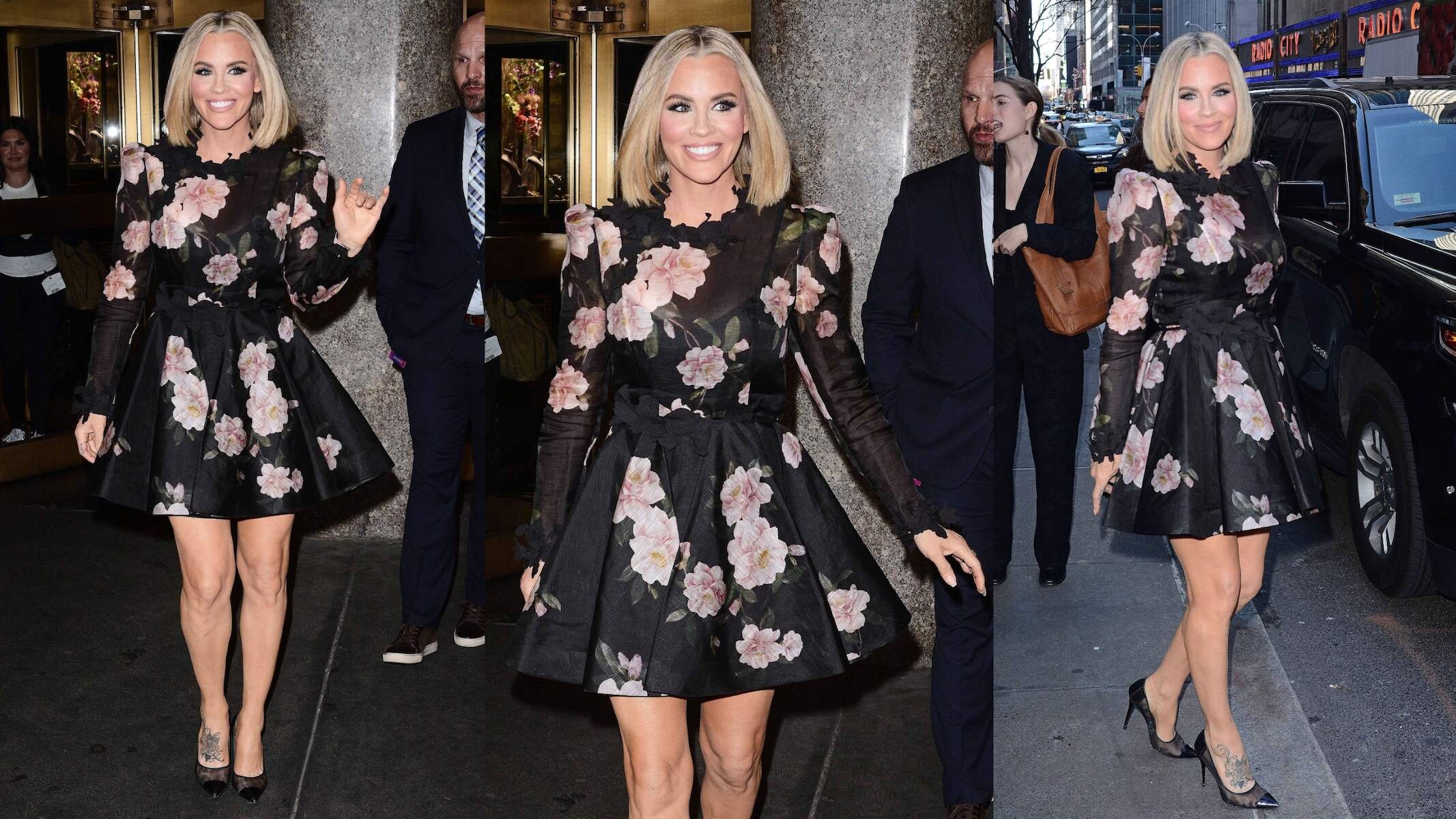 Actor Jenny McCarthy wears a black dress with pink flowers on it while standing on an NYC street