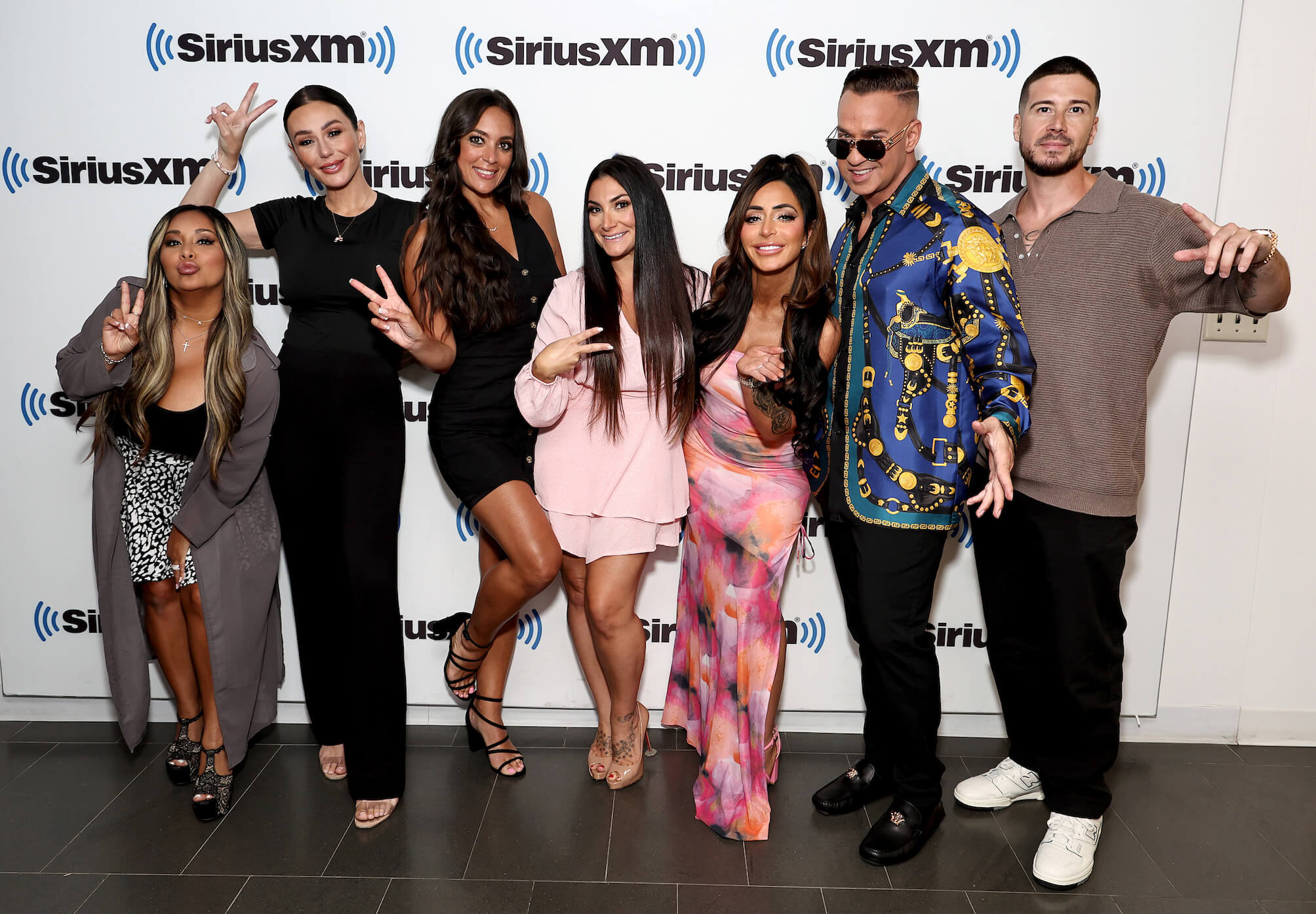 Nicole 'Snooki' Polizzi, Jenni 'JWoww' Farley, Sammi Giancola, Deena Nicole Cortese, Angelina Pivarnick, Mike 'The Situation' Sorrentino, and Vinny Guadagnino from 'Jersey Shore: Family Vacation' posing together for an event