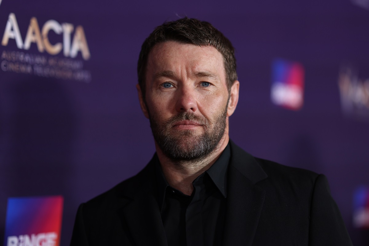 Joel Edgerton posing in a black suit at the 2024 AACTA Awards.