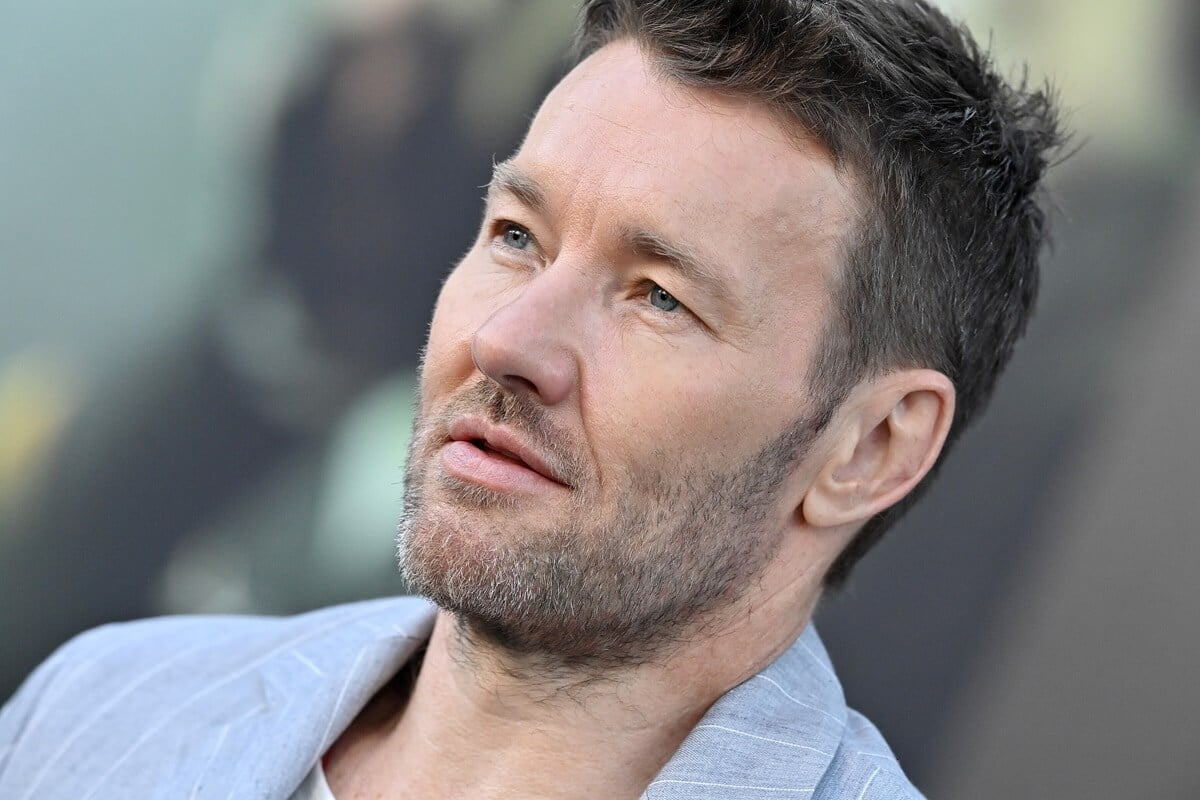 Joel Edgerton posing in a blue suit at the premiere of Prime Video's "Thirteen Lives".