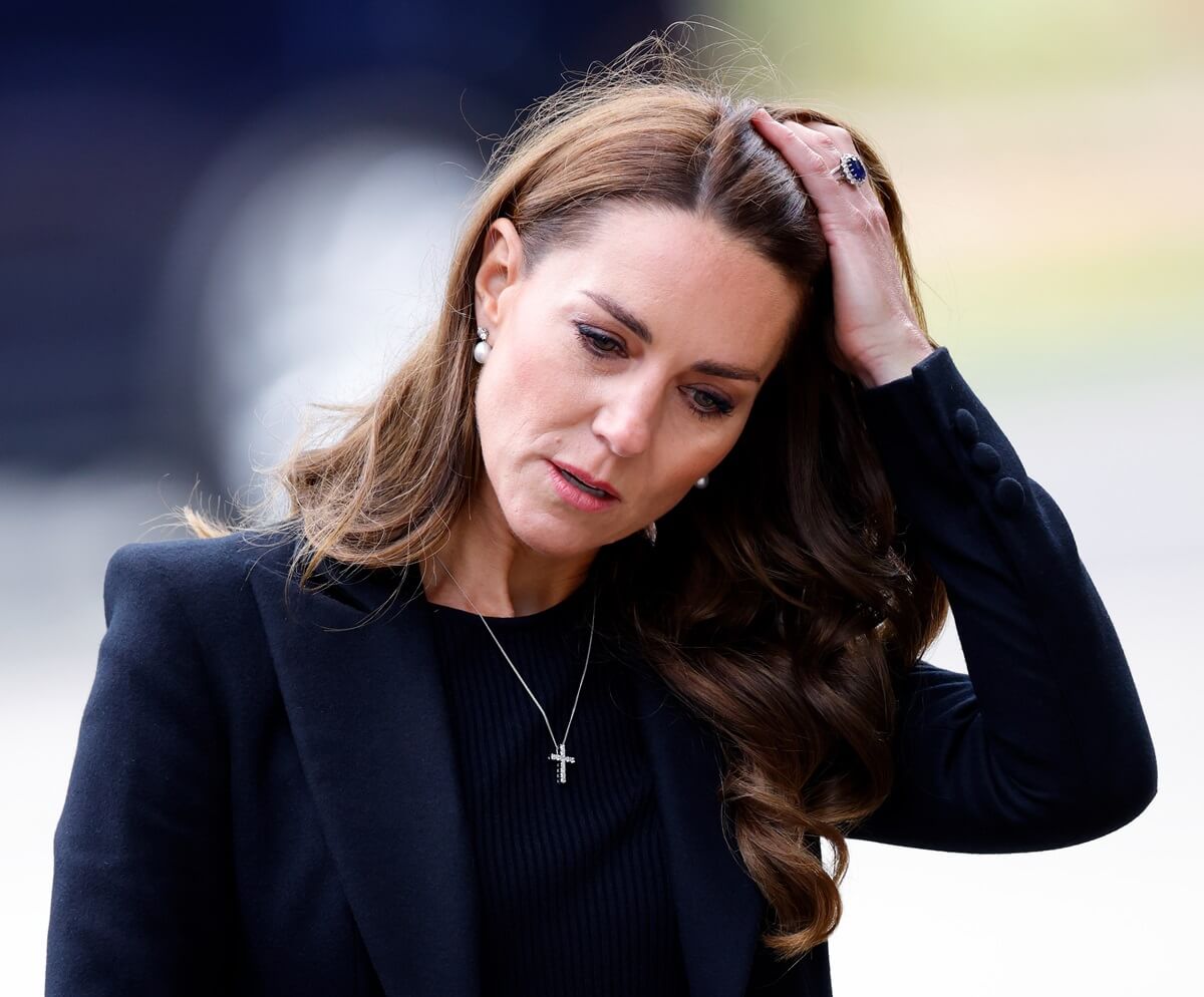 Kate Middleton views floral tributes left at the entrance to Sandringham House, the Norfolk estate of Queen Elizabeth II