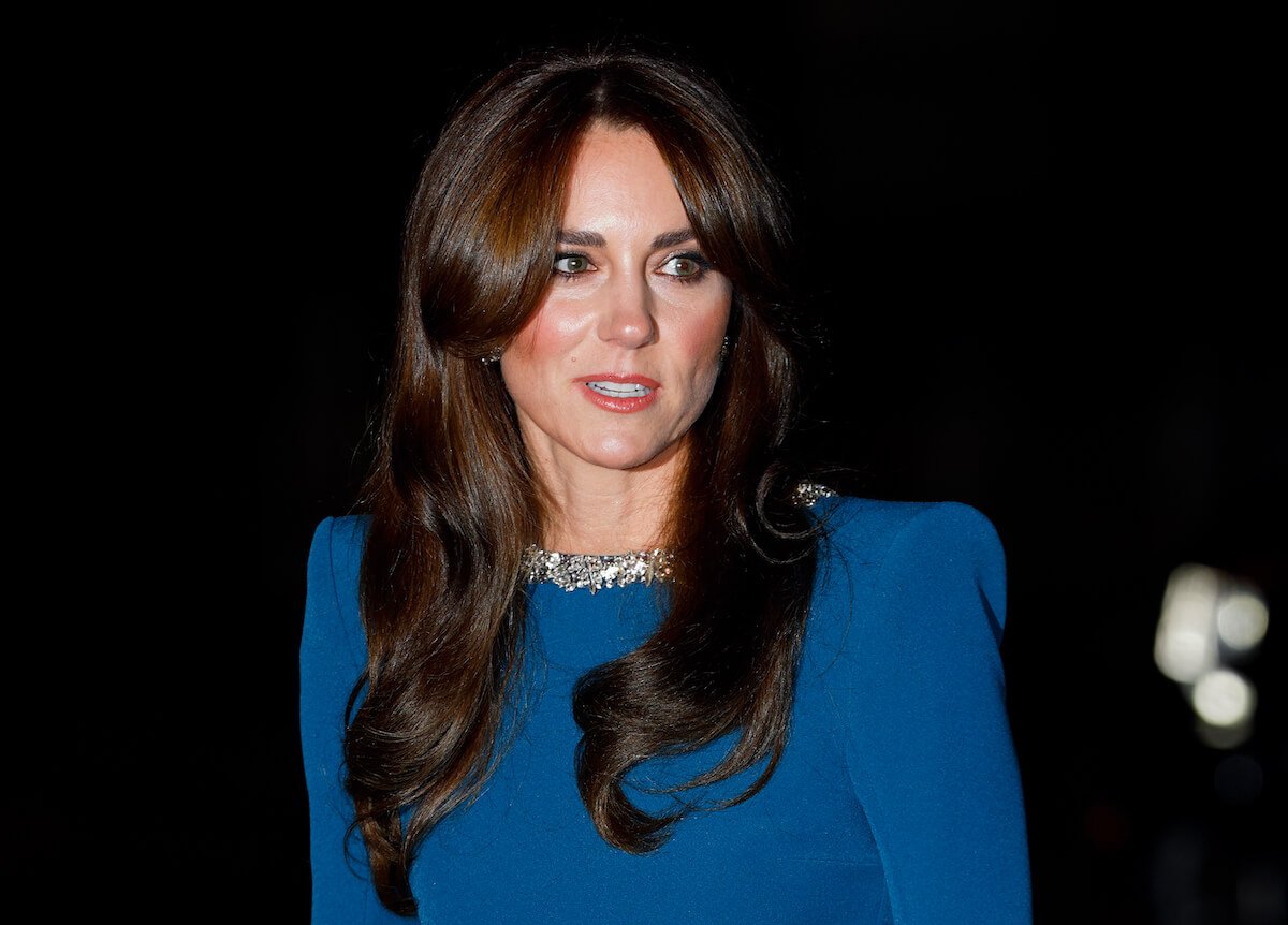 Kate Middleton, whose cancer announcement video wasn't a result of online 'drama,' per a report, looks on wearing blue