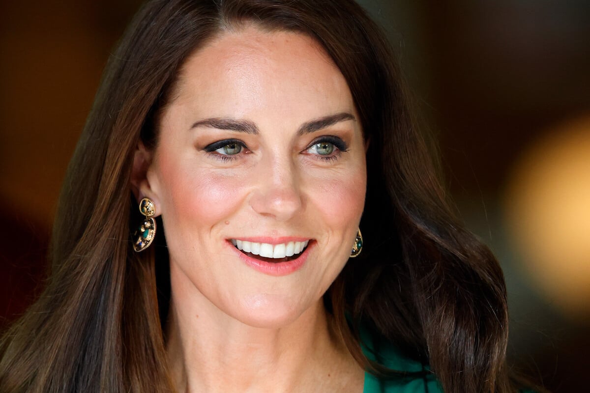 Kate Middleton, whose edited photo controversy sparked a new theory about photo agencies and the royal family, looks on