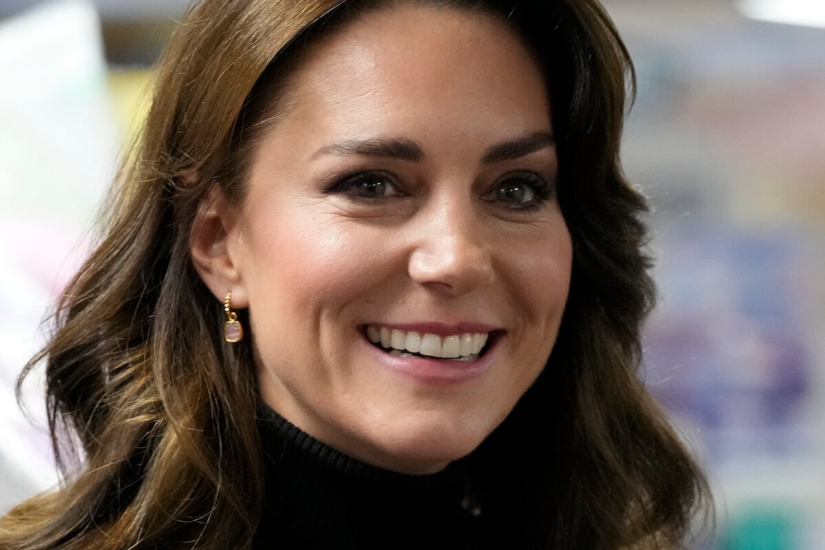 Kate Middleton, whose surgery recovery Kensington Palace has been urged to be 'candid' about by commentators, smiles