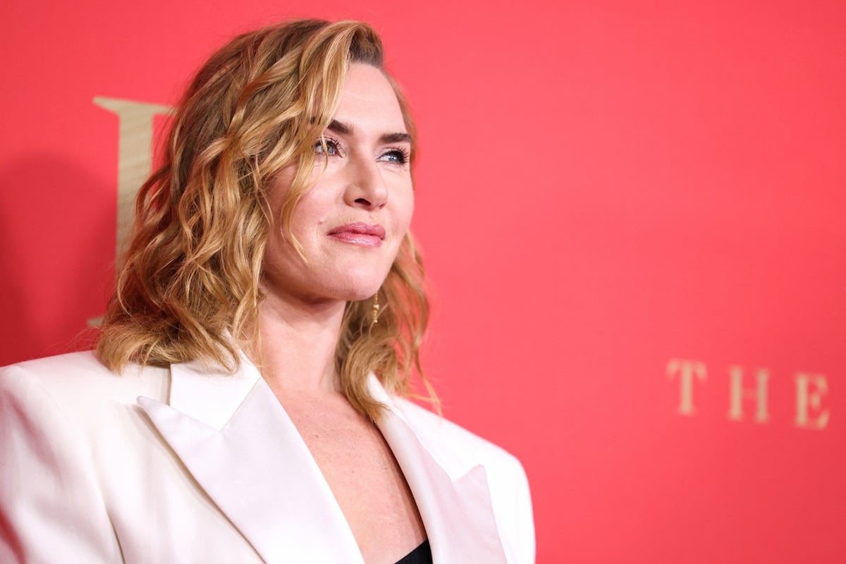 Kate Winslet posing while wearing a white blazer at the premiere of 'The Regime'.