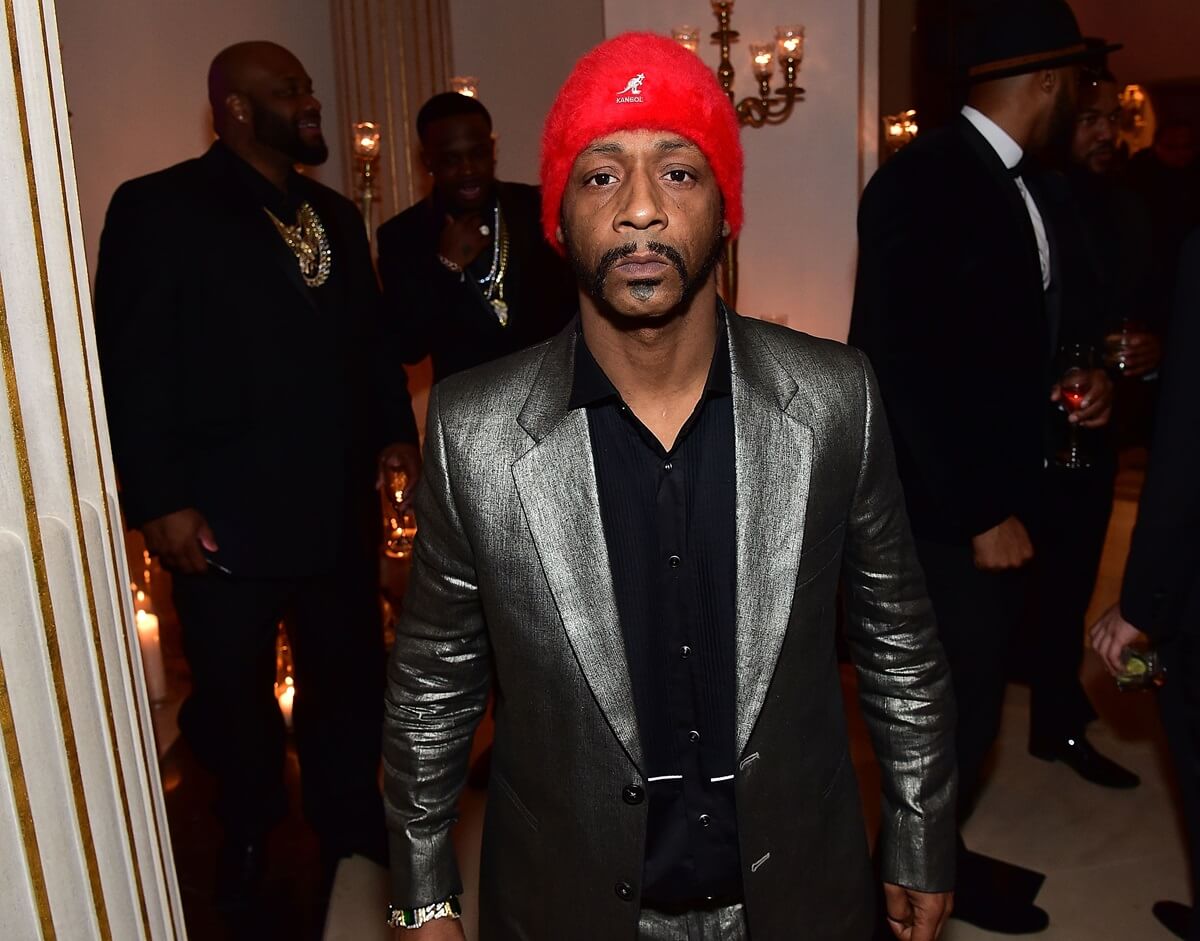 Katt Williams posing in a silver and black outfit at Rick Ross' ' 40th Birthday Celebration.