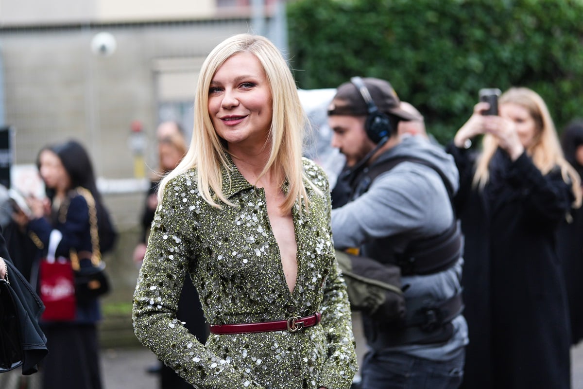 Kirsten Dunst posing in a green dress during fashion week.