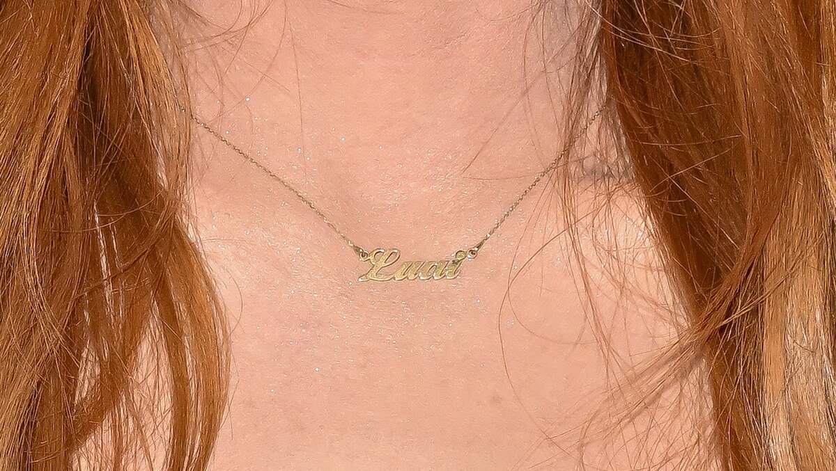 Actor Lindsay Lohan wears a nameplate necklace 'Luai,' her son's name