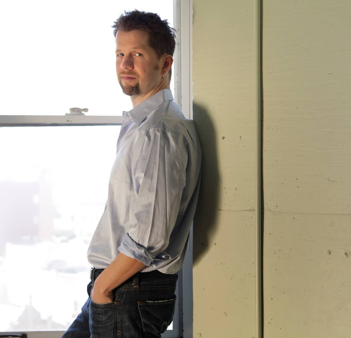 Chris Coelen posing on a wall.