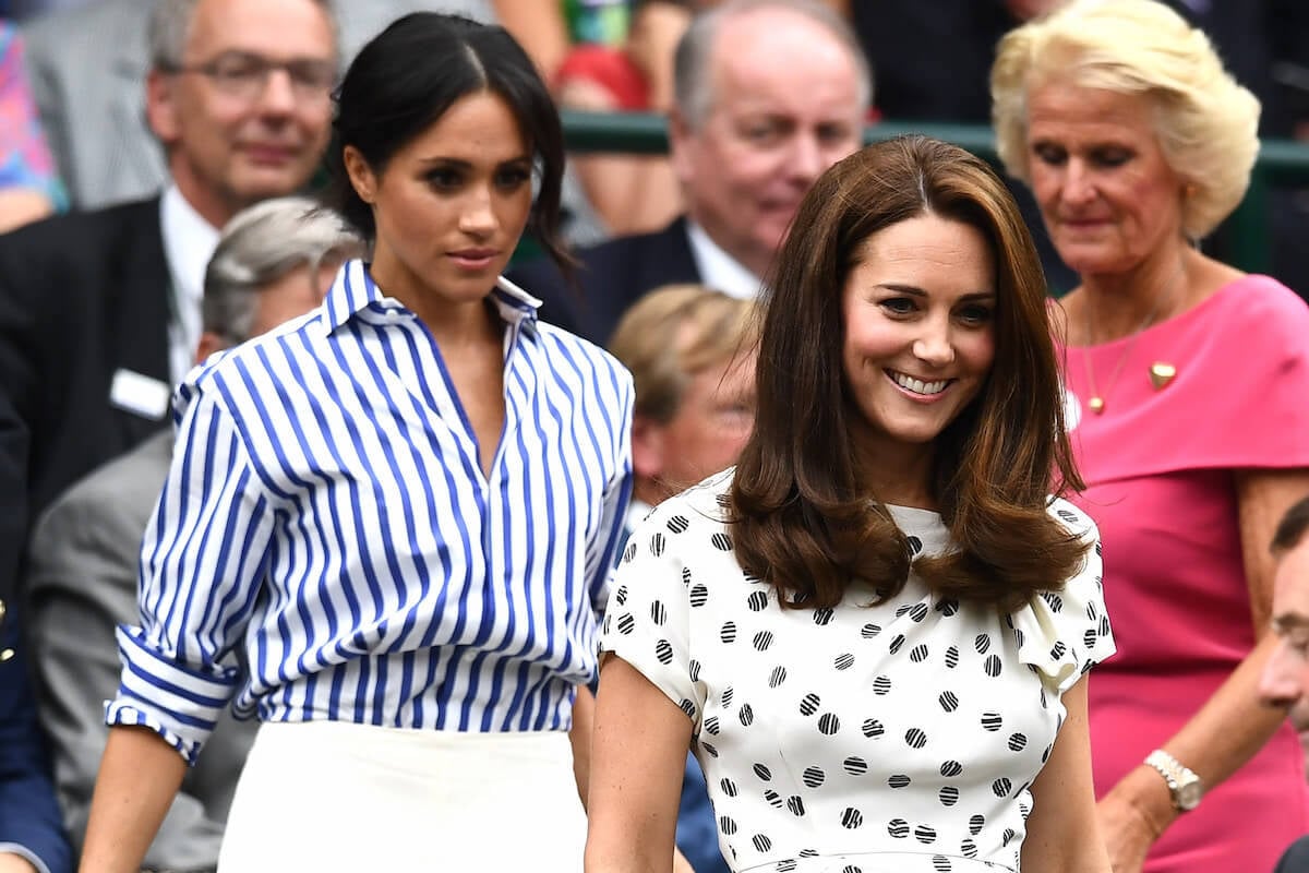 Meghan Markle and Kate Middleton, whose Mother's Day photo prompted questions about bridesmaid dress drama, walk together at Wimbledon