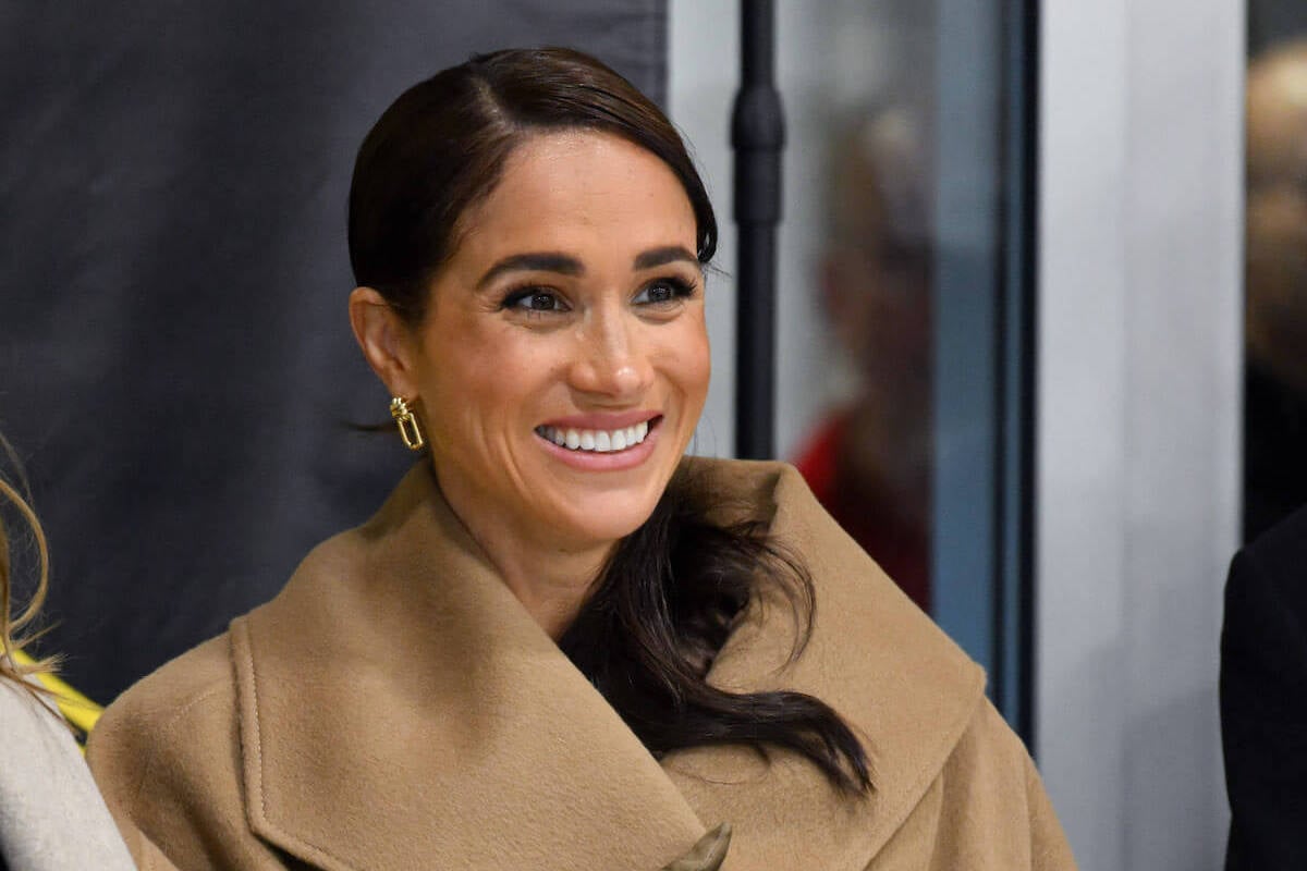 Meghan Markle, whose reportedly hired a celebrity stylist, looks on smiles